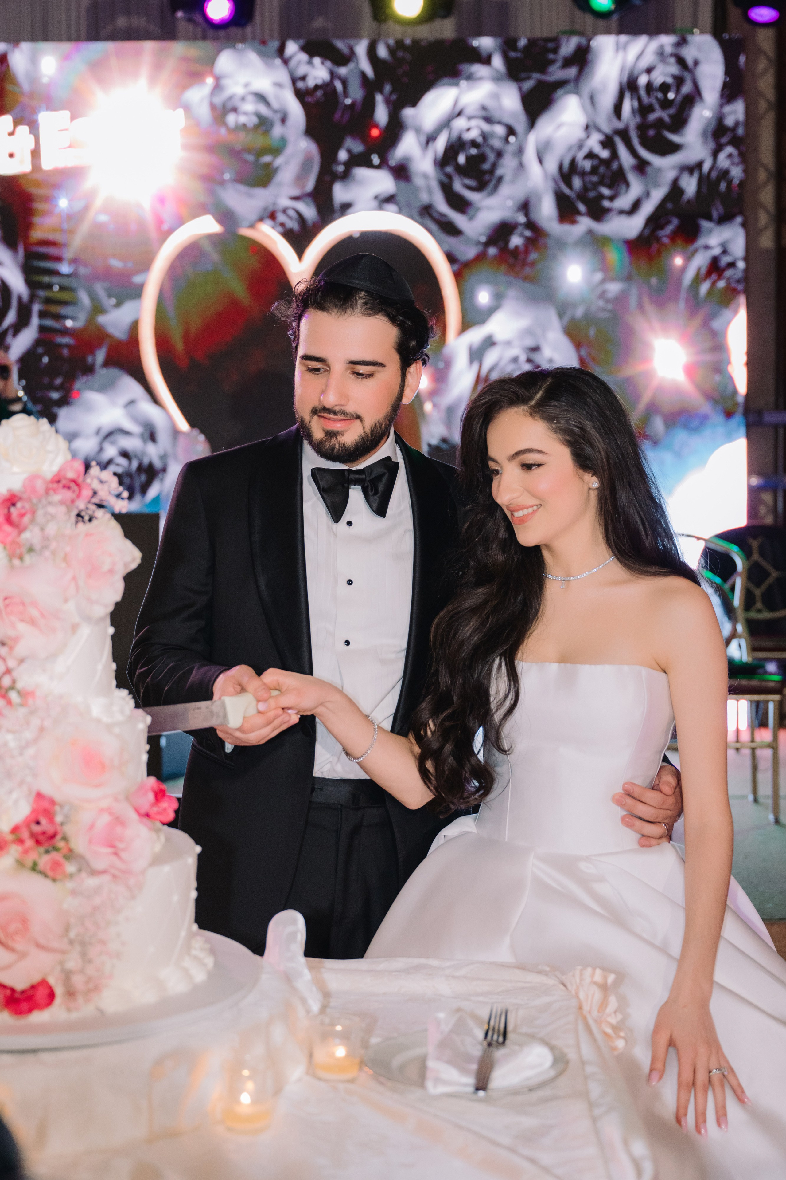a man and woman cutting a cake