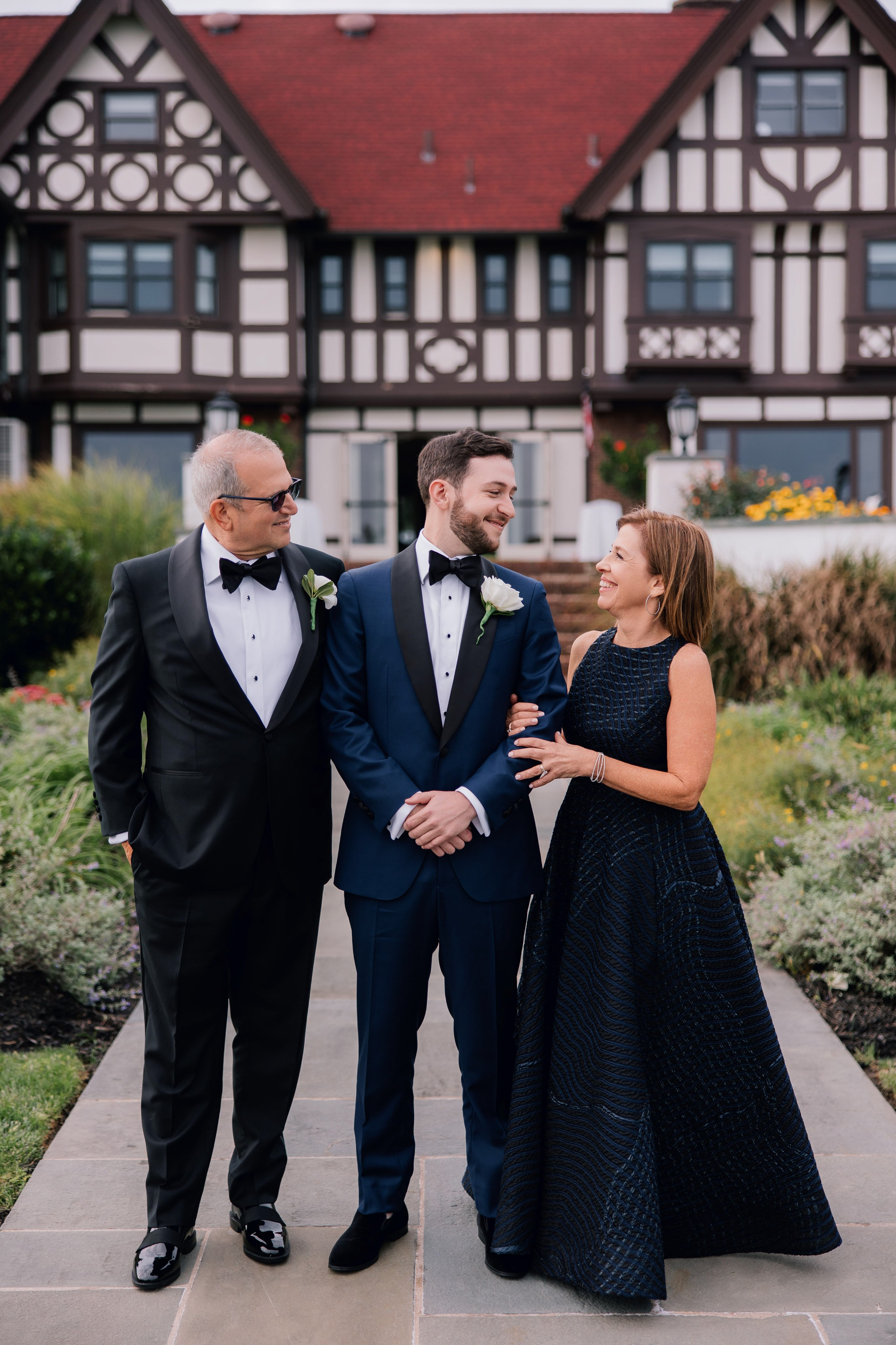 a man in a suit and tie standing next to a woman in a black dress