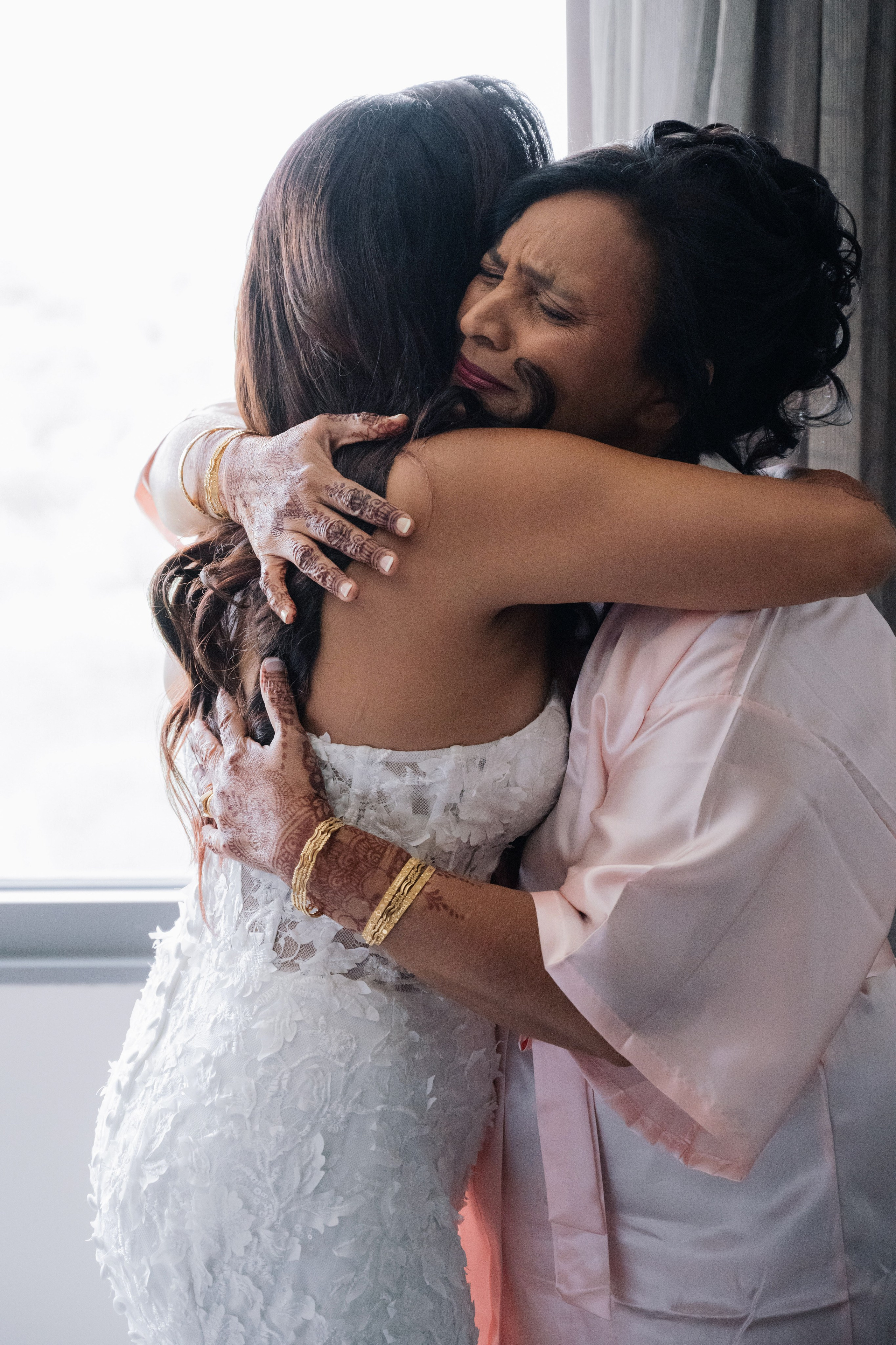 a bride hugging her mother