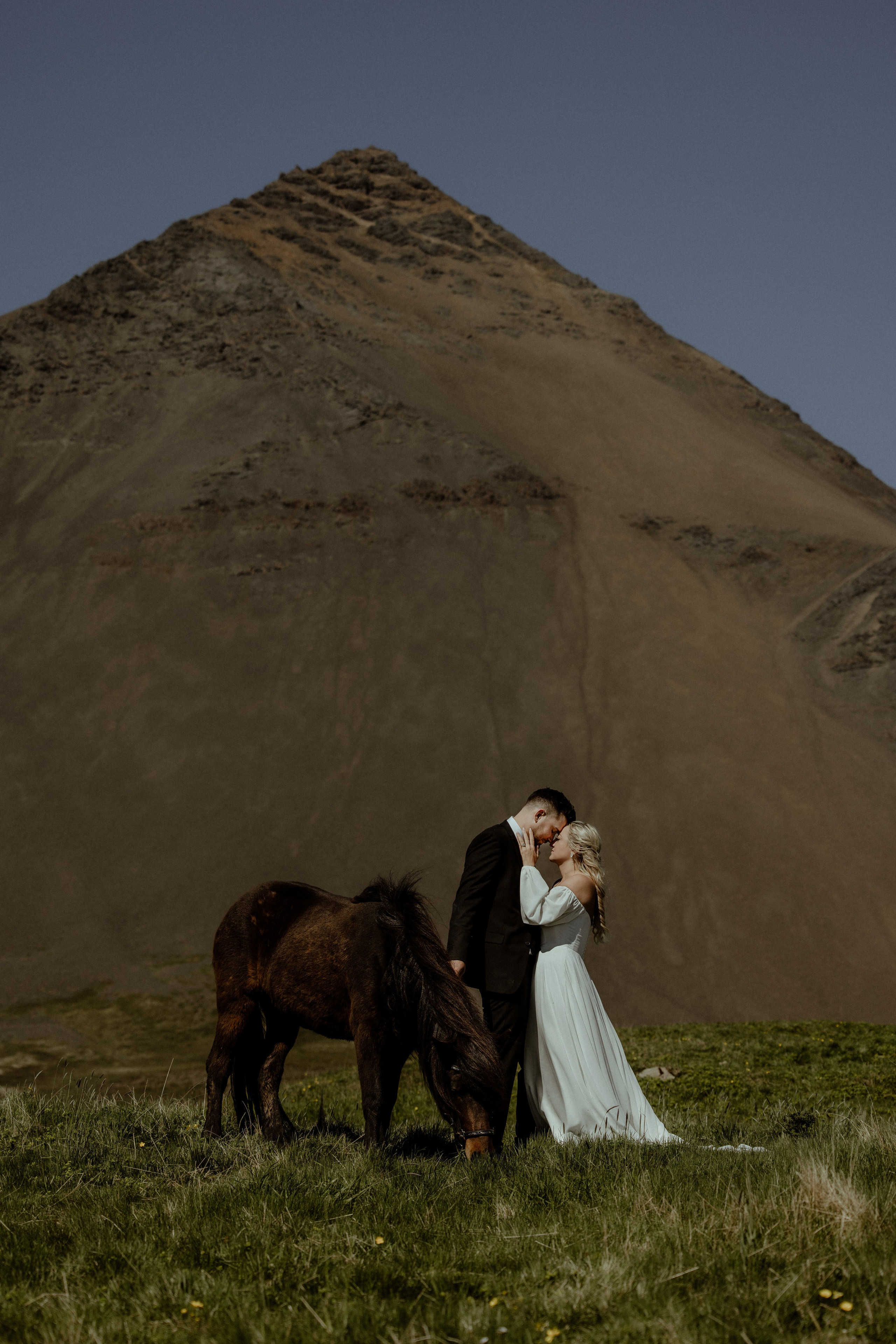 Iceland elopement at Budir with midnight sun wedding photos at black sand beach. Iceland elopement photographer & videographer
