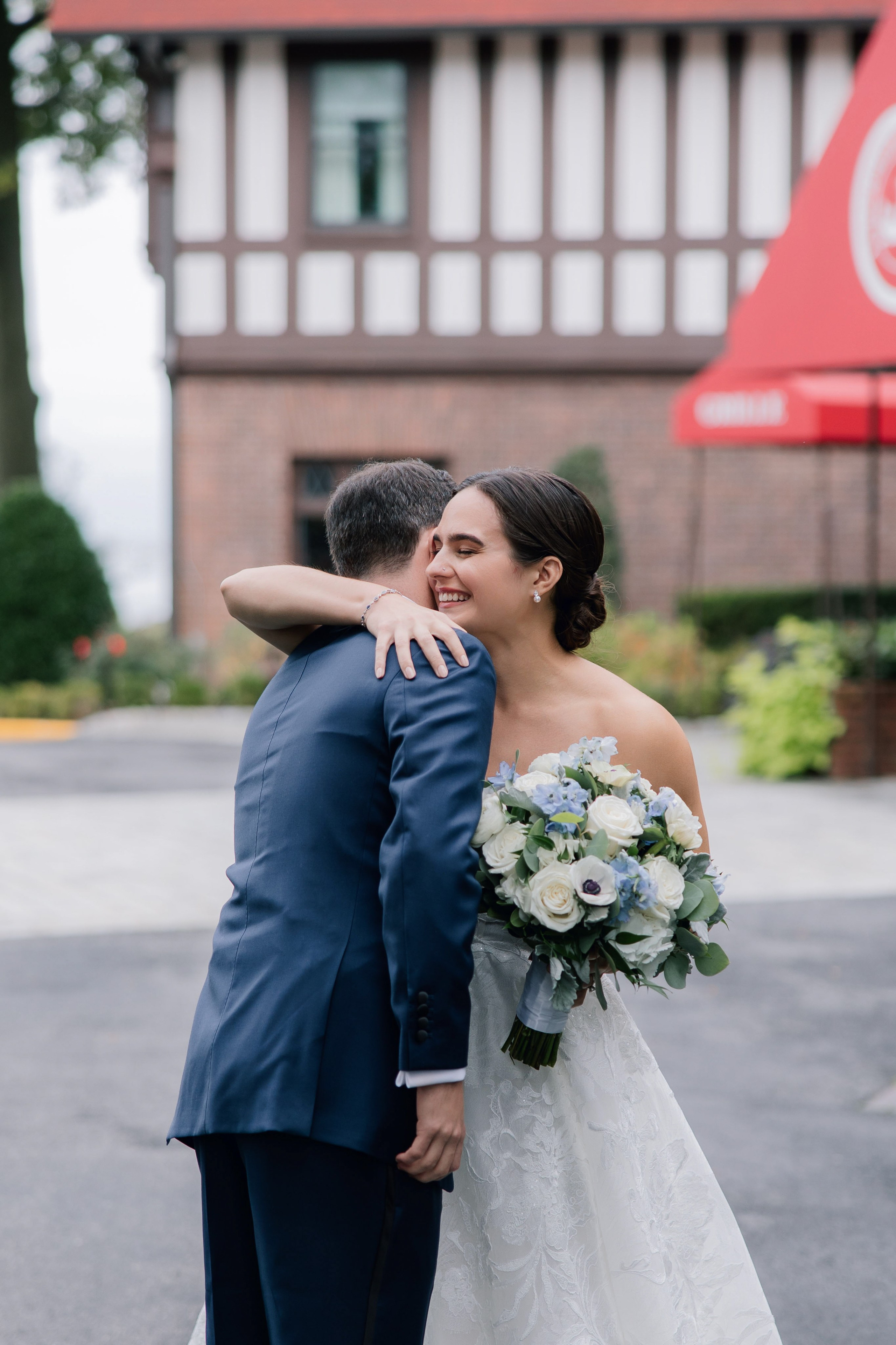 a bride and groom share a moment in front of the red arrow inn