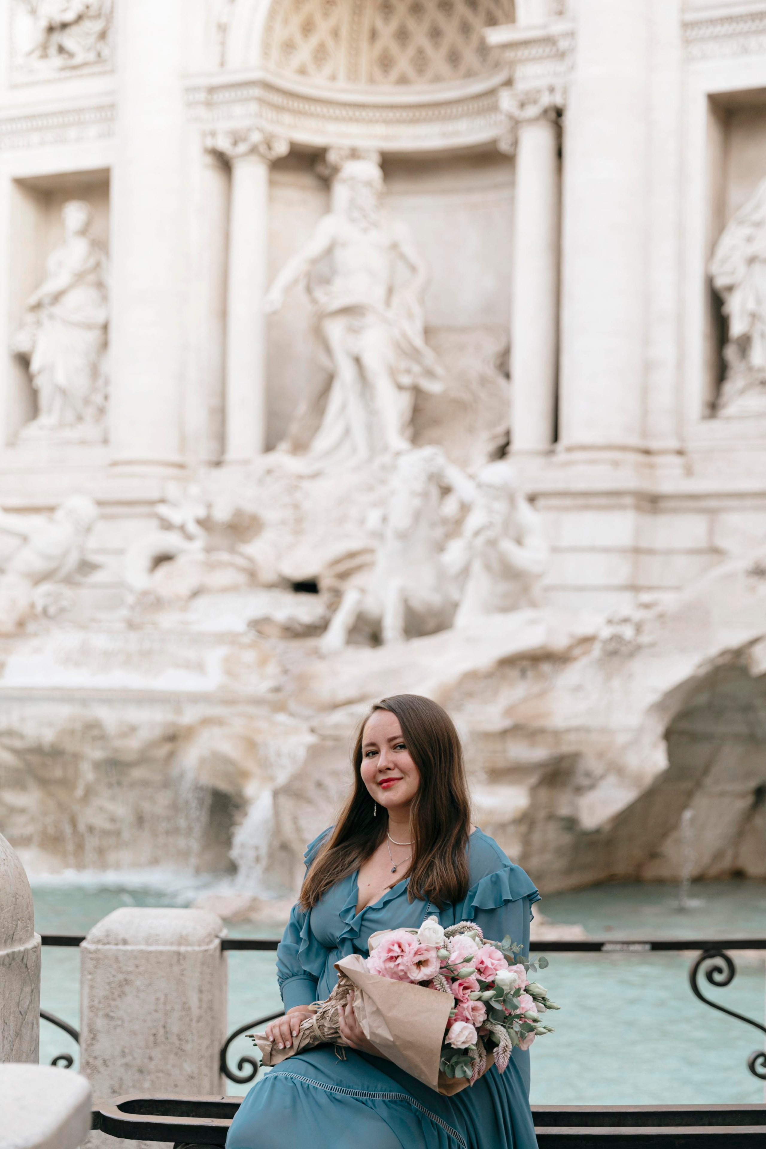 THREE COINS IN THE TREVI FOUNTAIN. Photographer in Rome