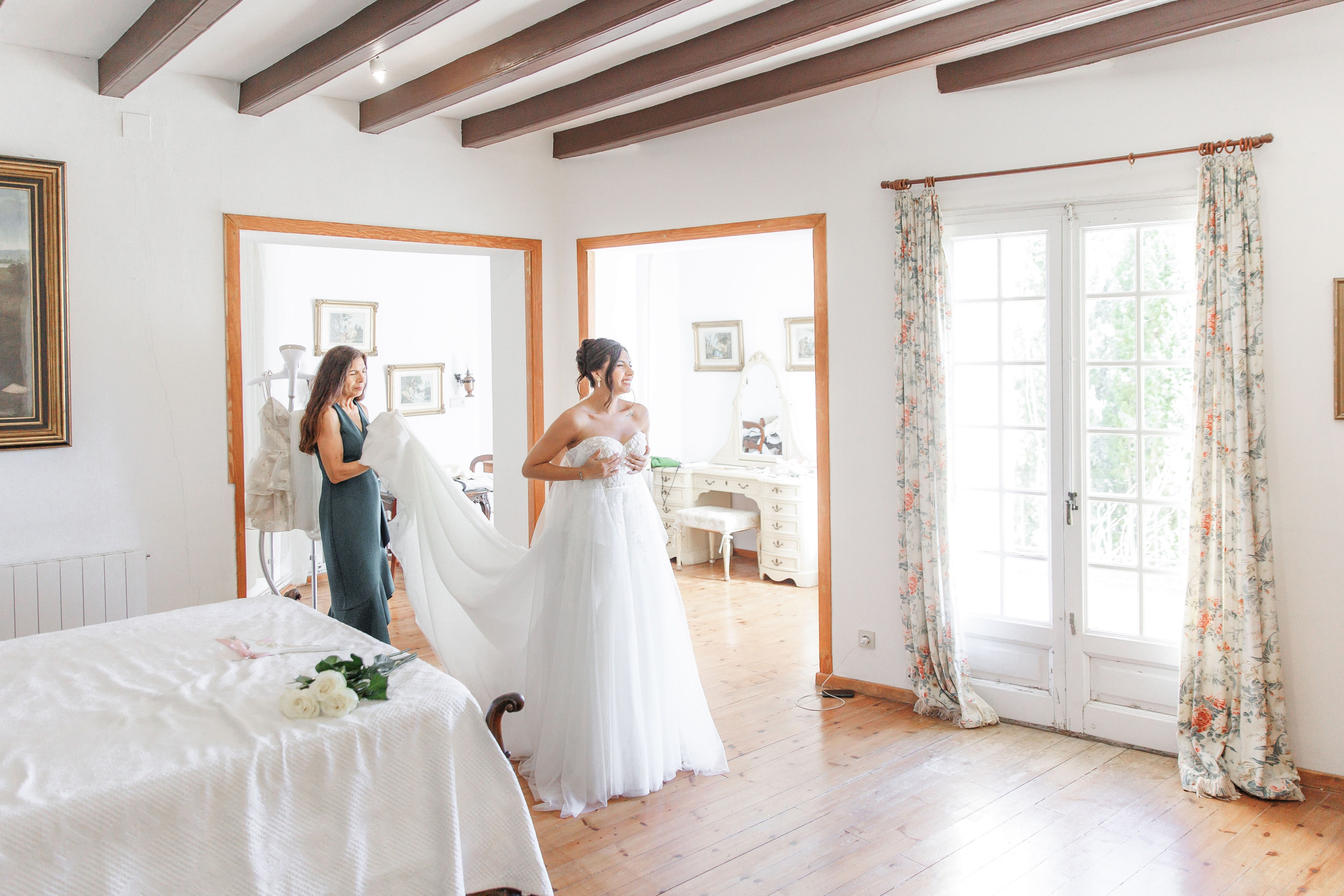 The bride shares a joyful moment with her mother before the wedding ceremony in Barcelona.