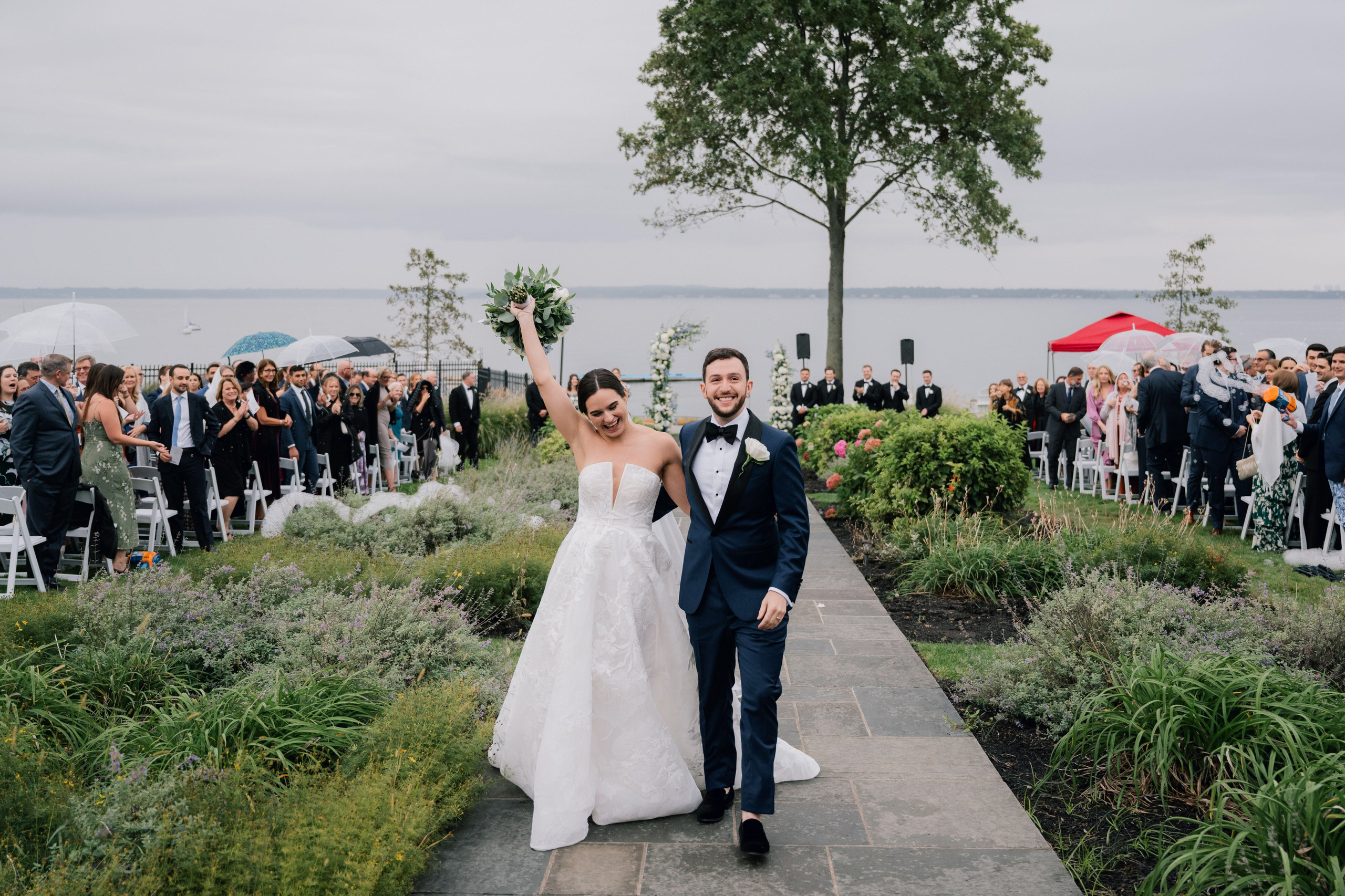 a bride and groom walking down the aisle at their wedding