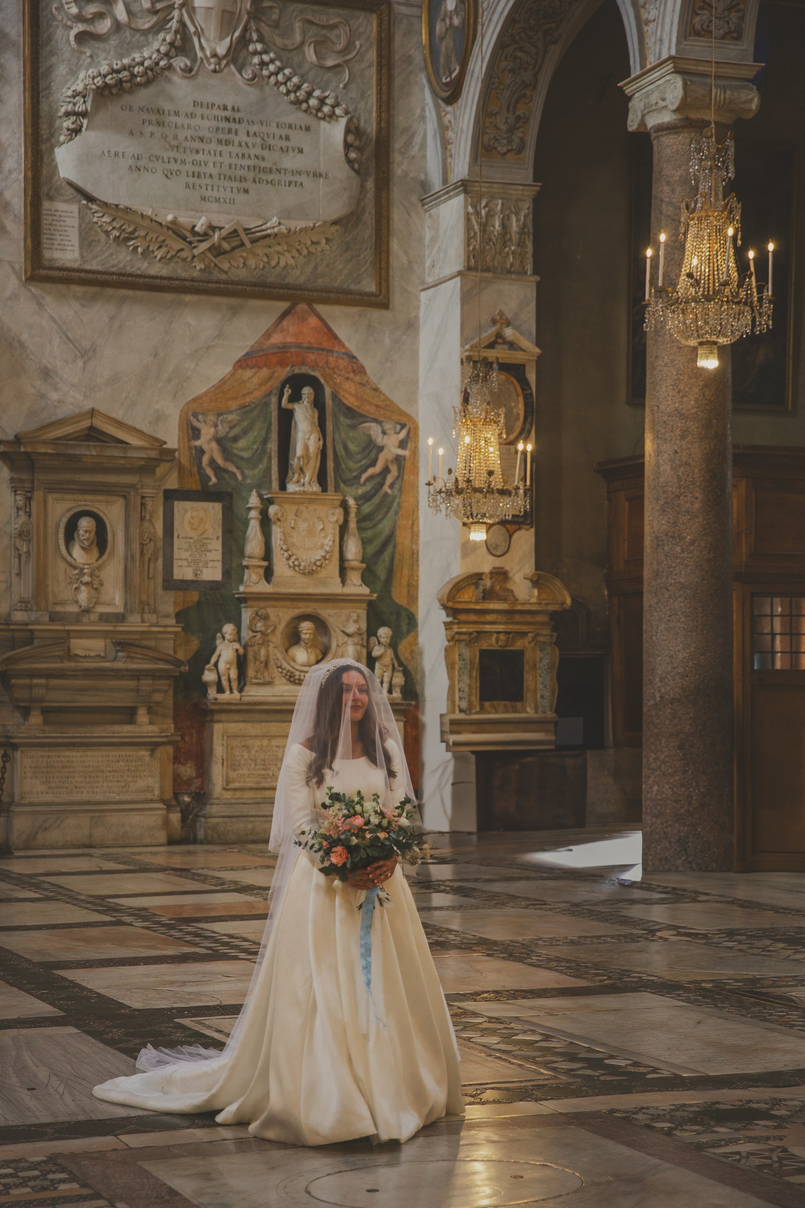 The bride walks down the aisle to the altar at Santa Maria in Aracoeli in Rome.