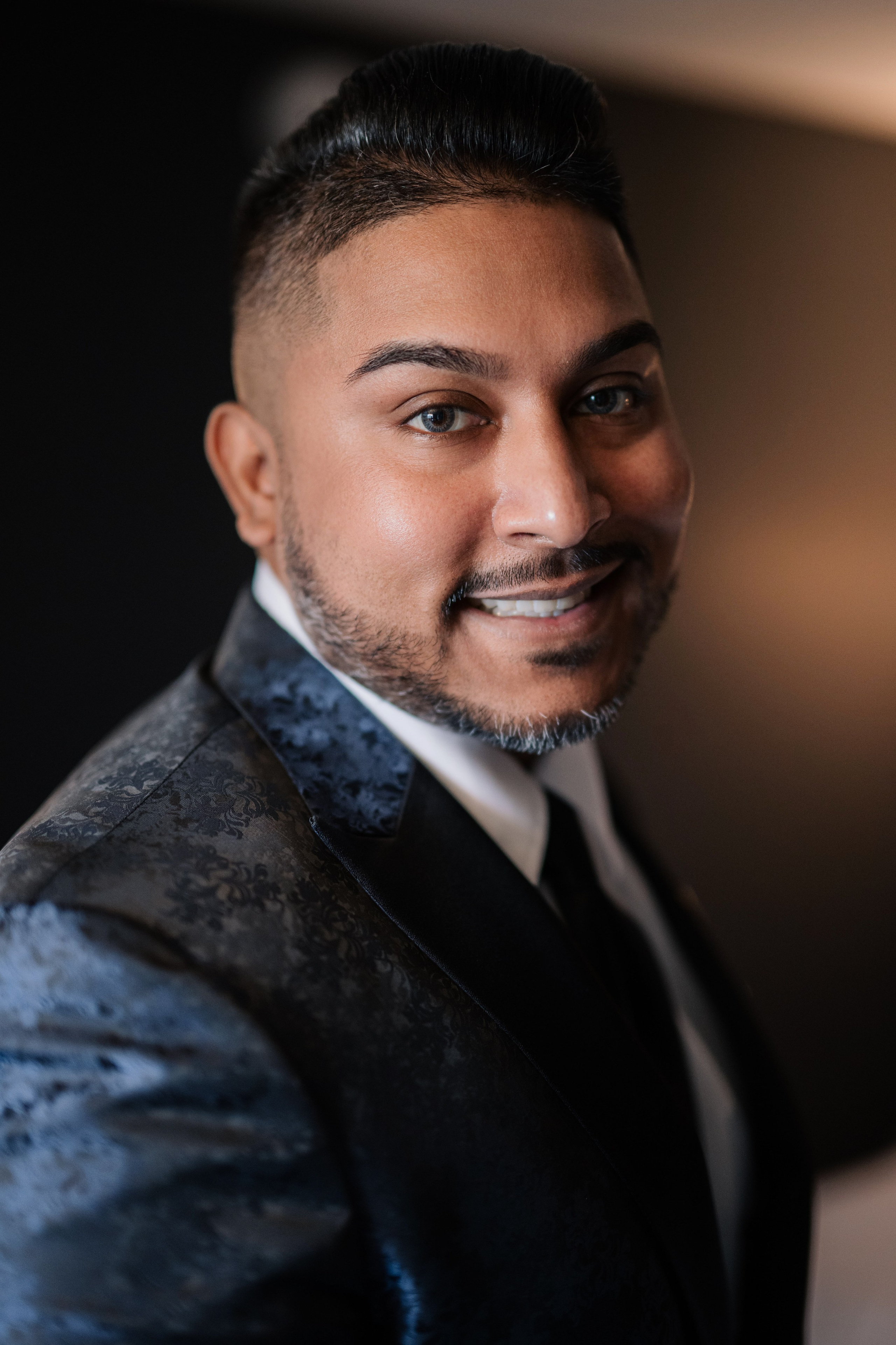 a man in a suit and tie smiling