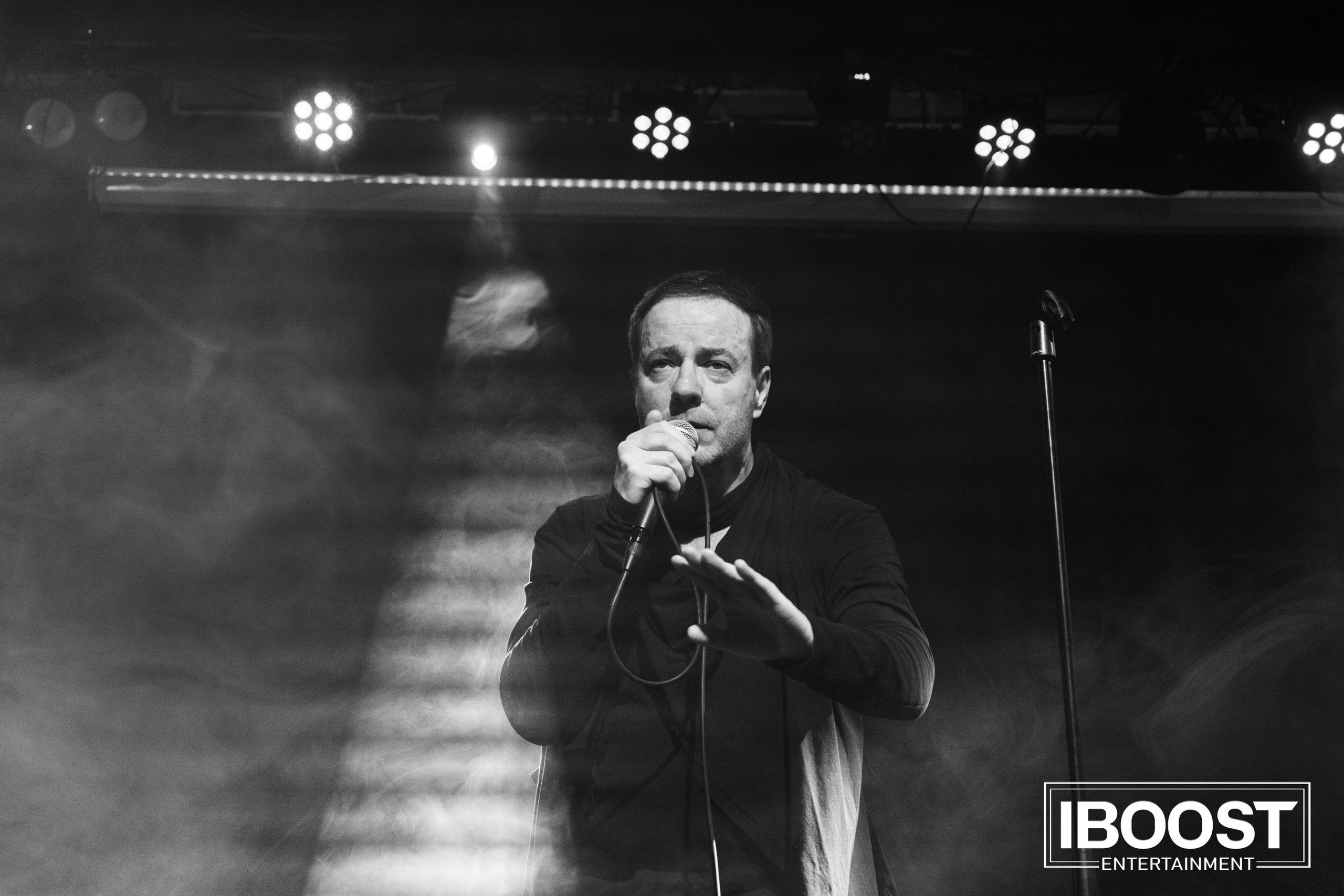 Black-and-white stage portrait of vocalist Krasovitsky singing into a microphone during the Animal JazZ concert in Sofia.