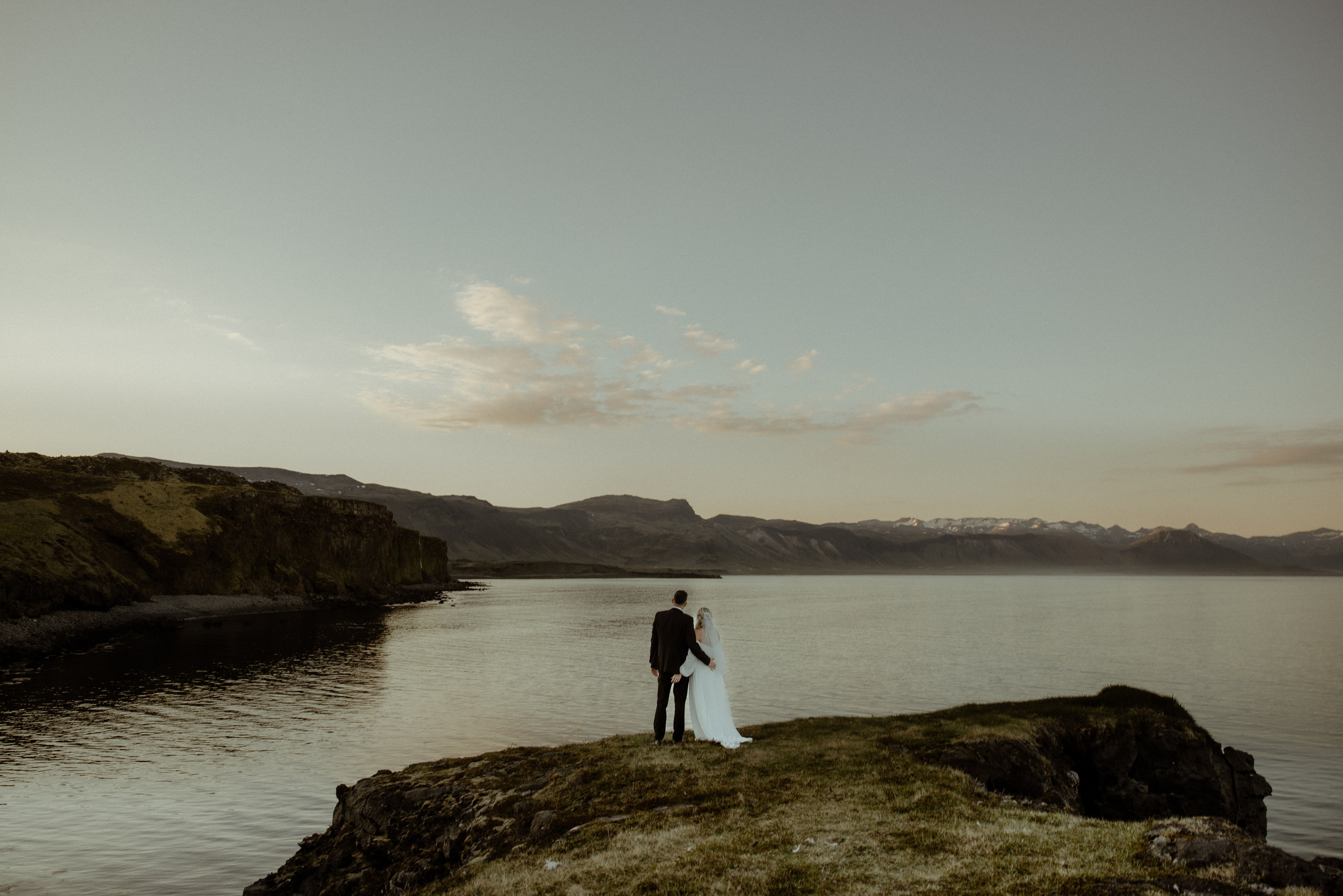 Iceland elopement at Budir with midnight sun wedding photos at black sand beach. Iceland elopement photographer & videographer