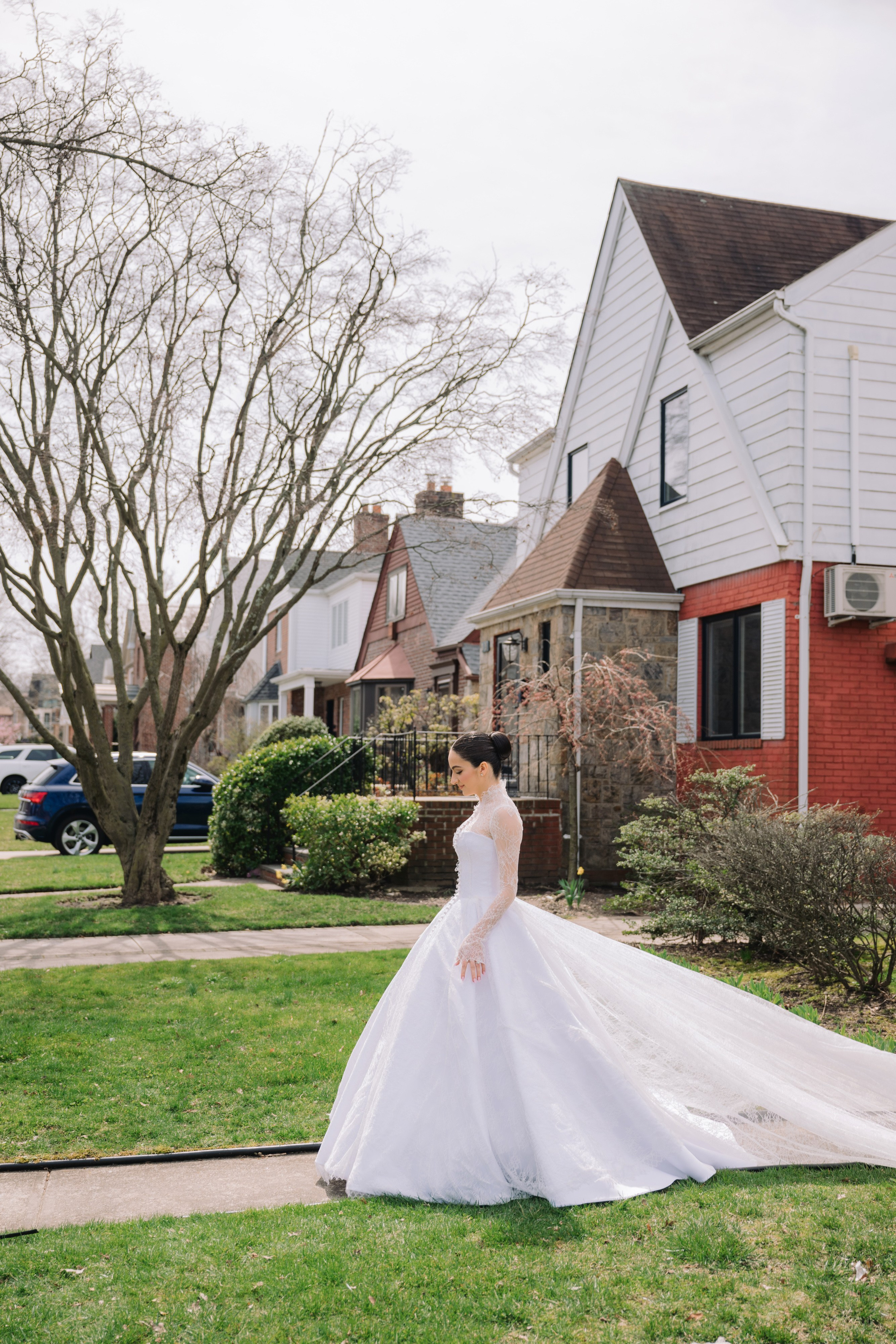 a bride in a white wedding dress walking down the street