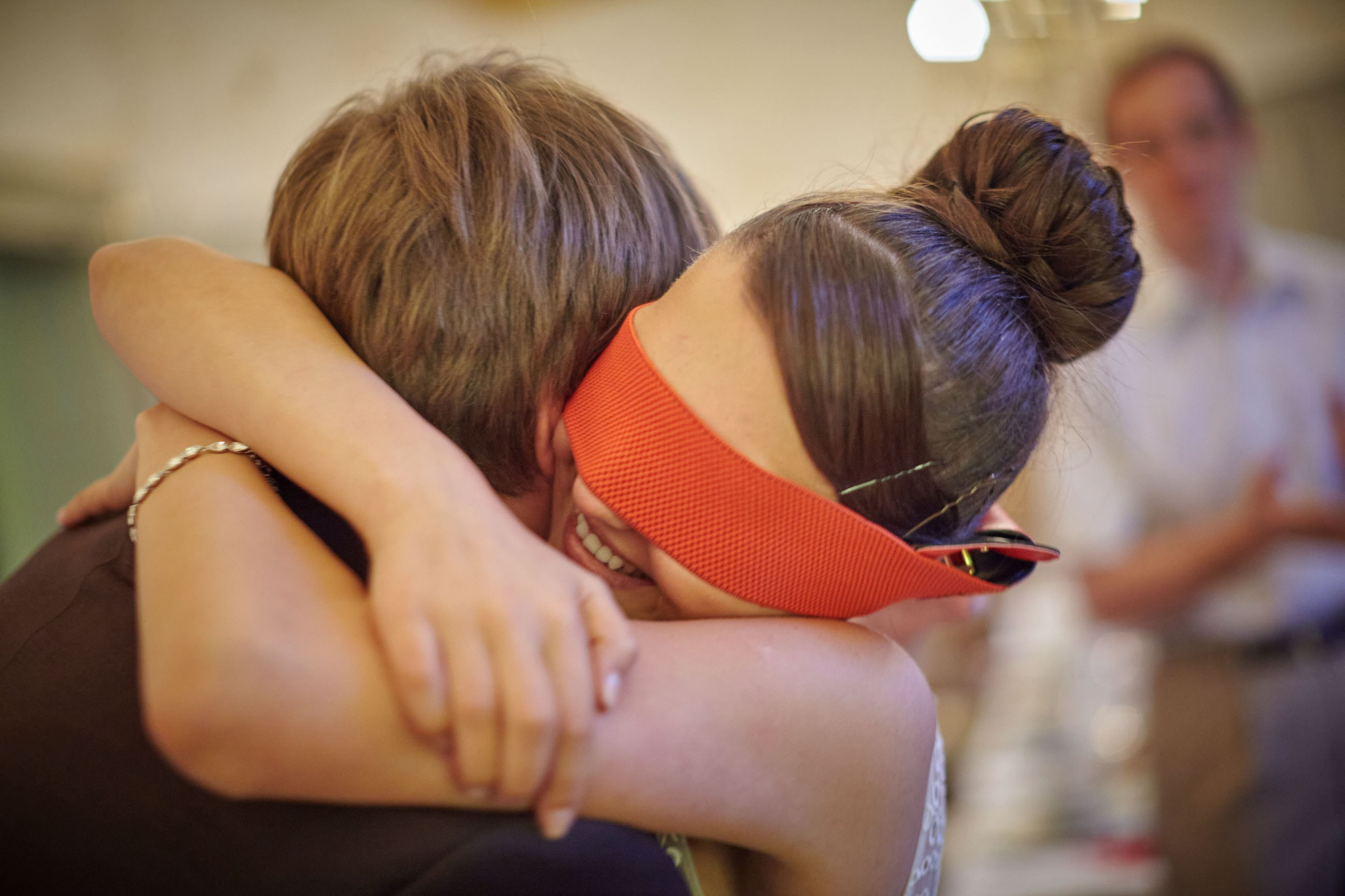 A blindfolded bride celebrates her ability to correctly chose her groom by using only her touch in a wedding game.