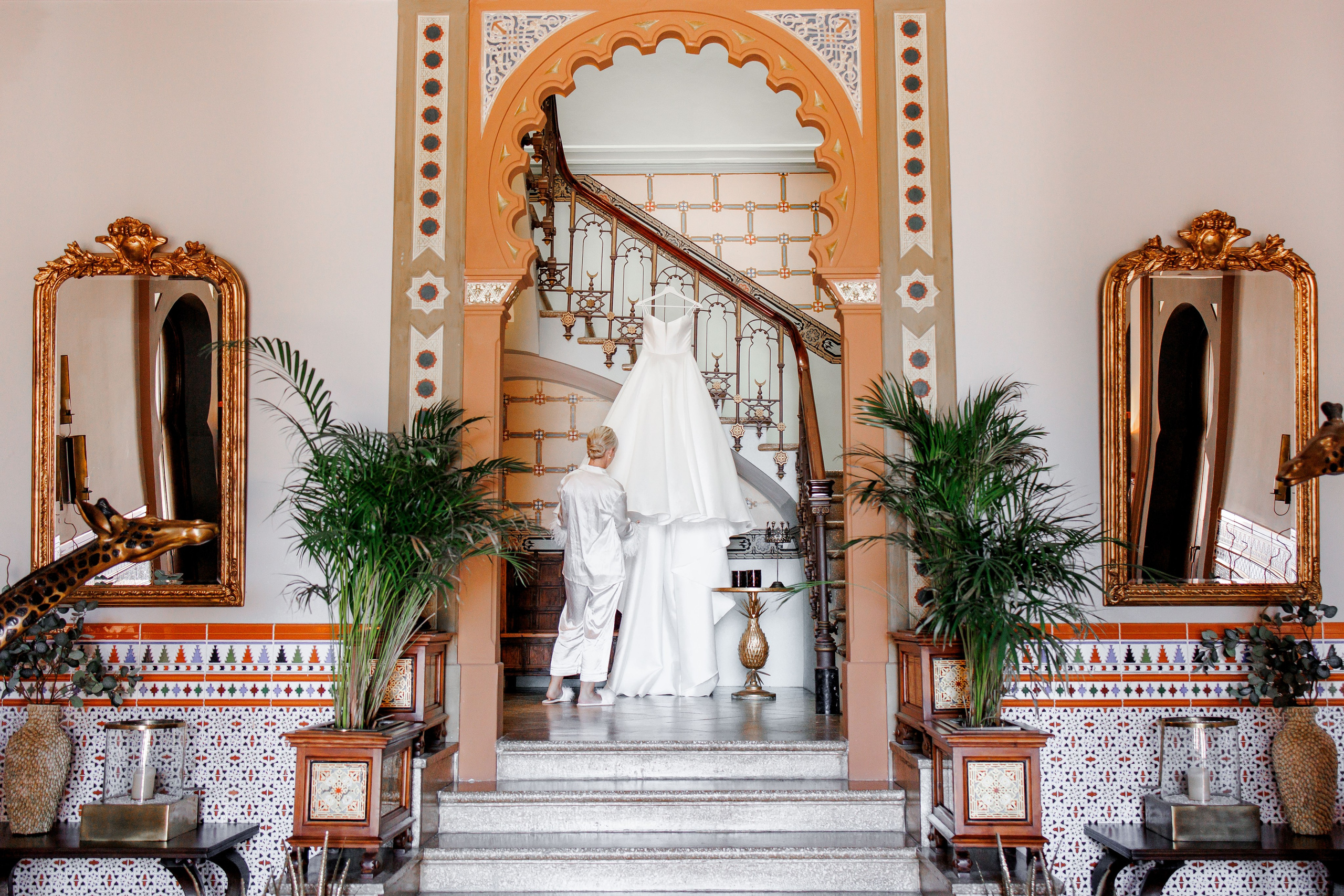 The bride is adjusting her wedding dress before the wedding ceremony starts at Gran Villa Rosa
