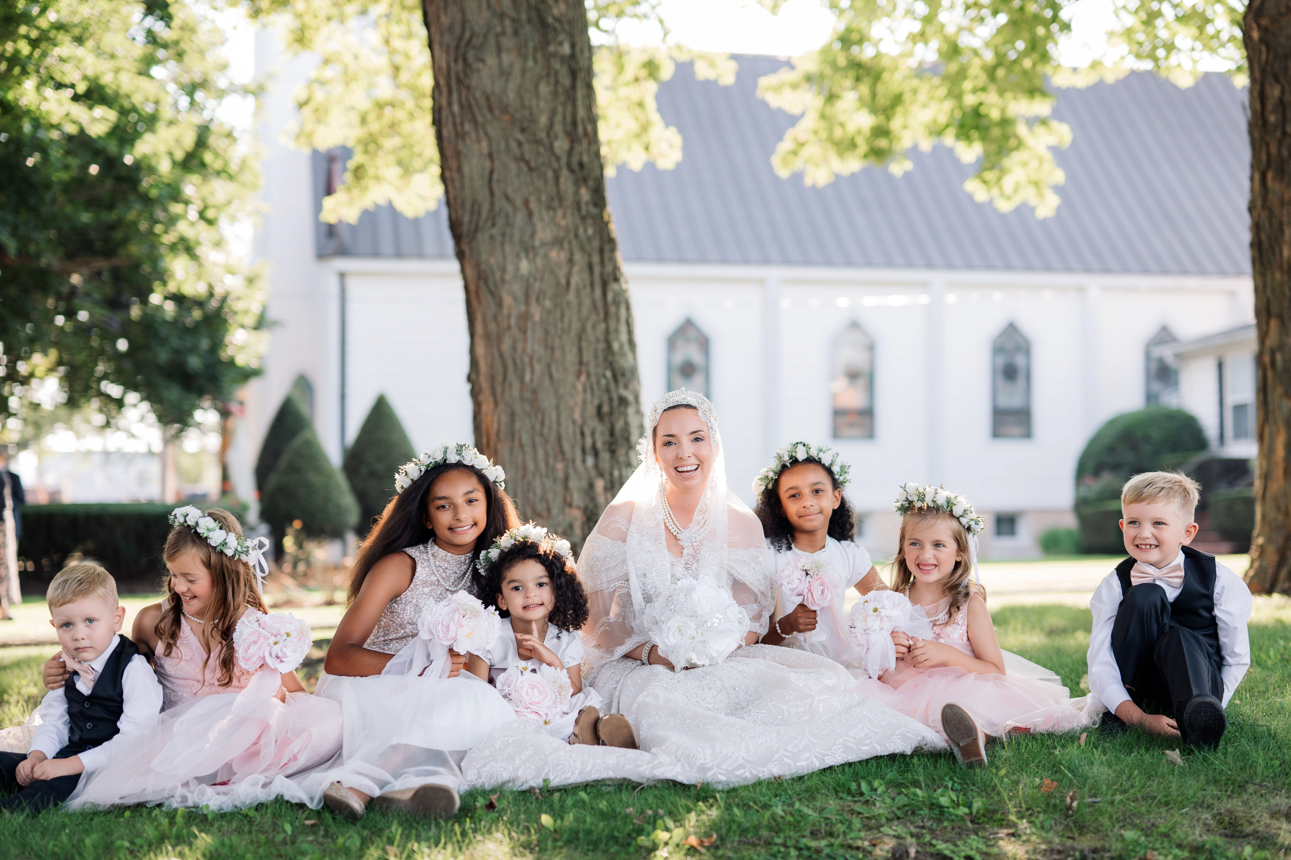 a group of children sitting on the grass