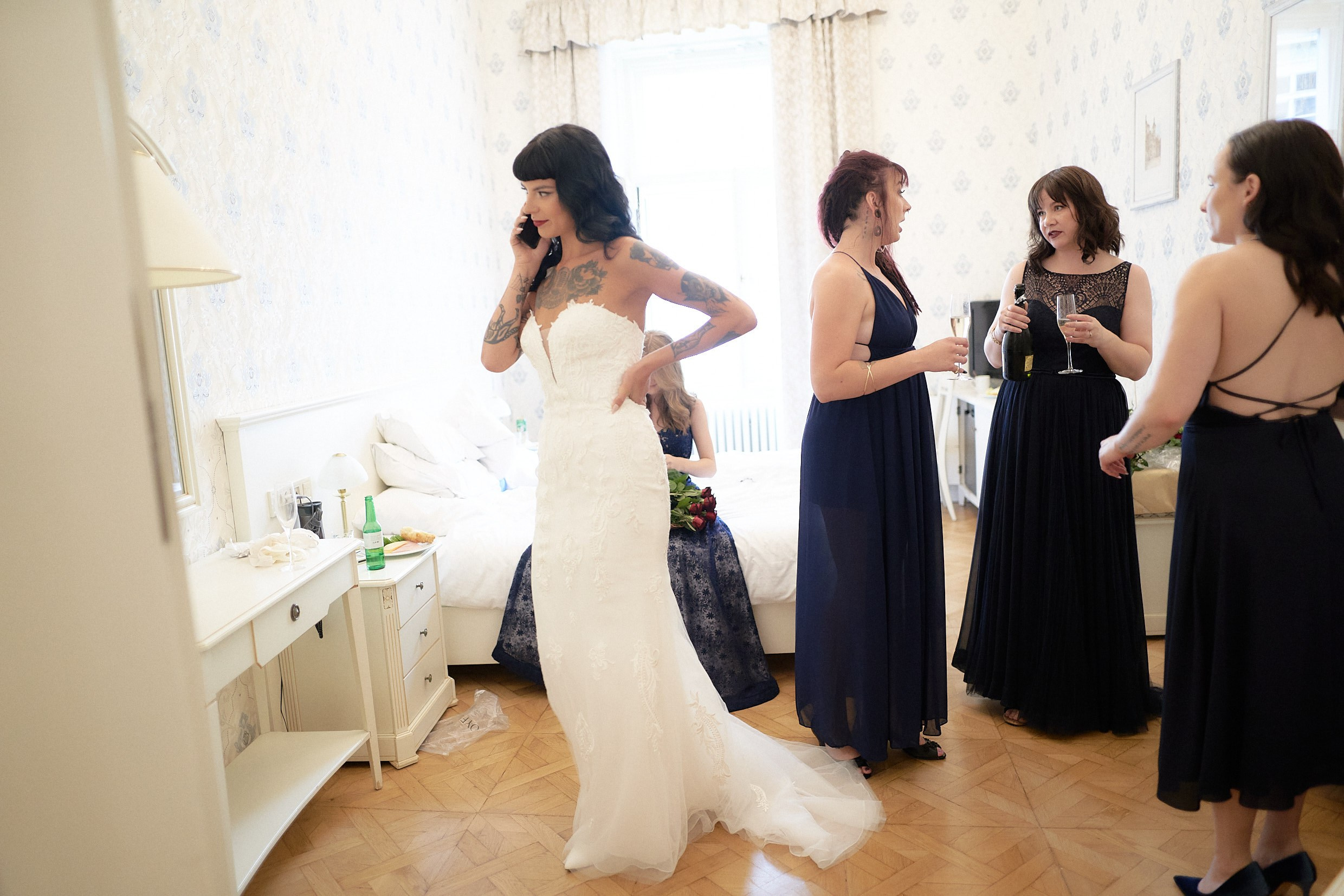 Bride on phone confirming groom's readiness before first look.