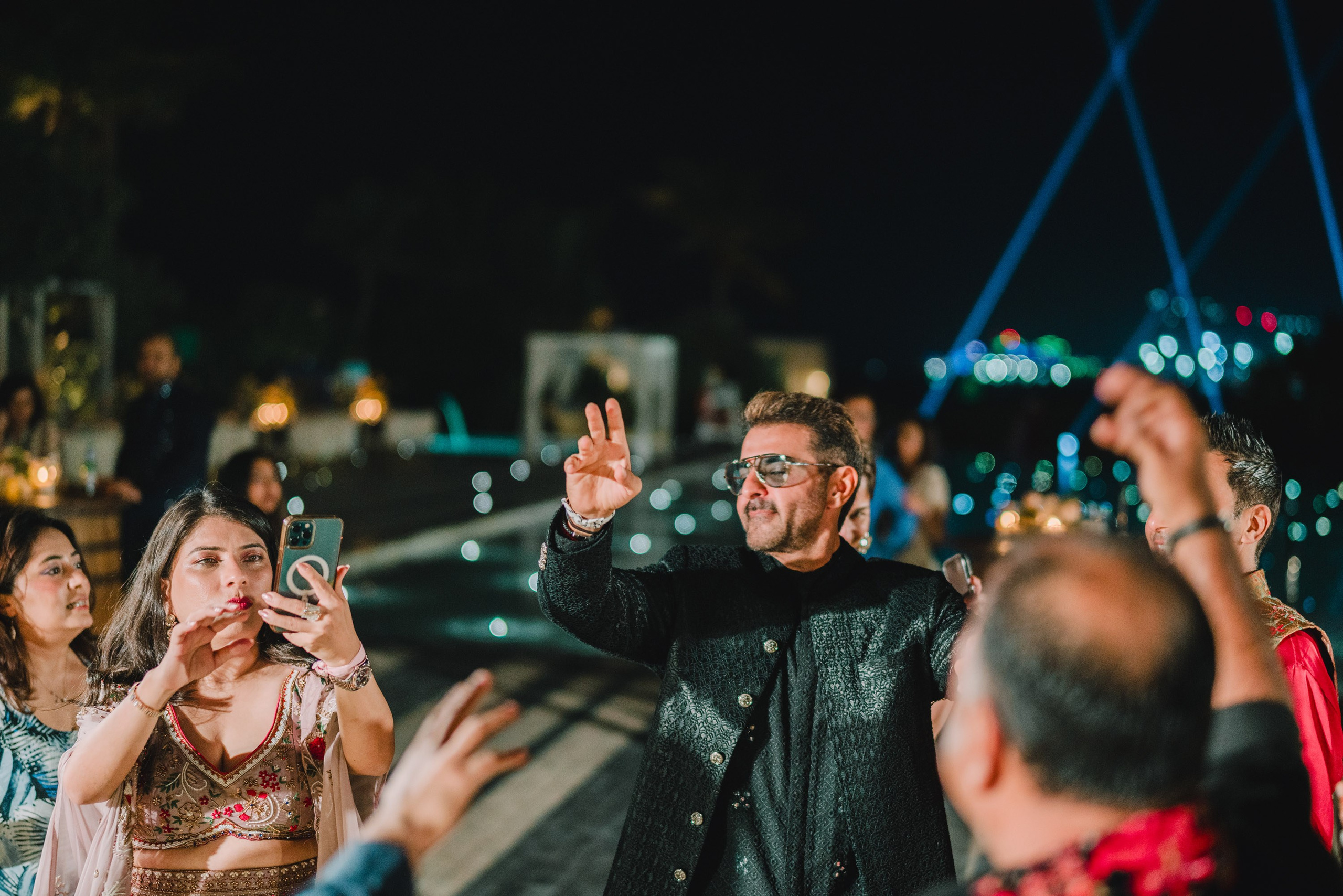 Gentlemen with a red scarf dancing on wedding party