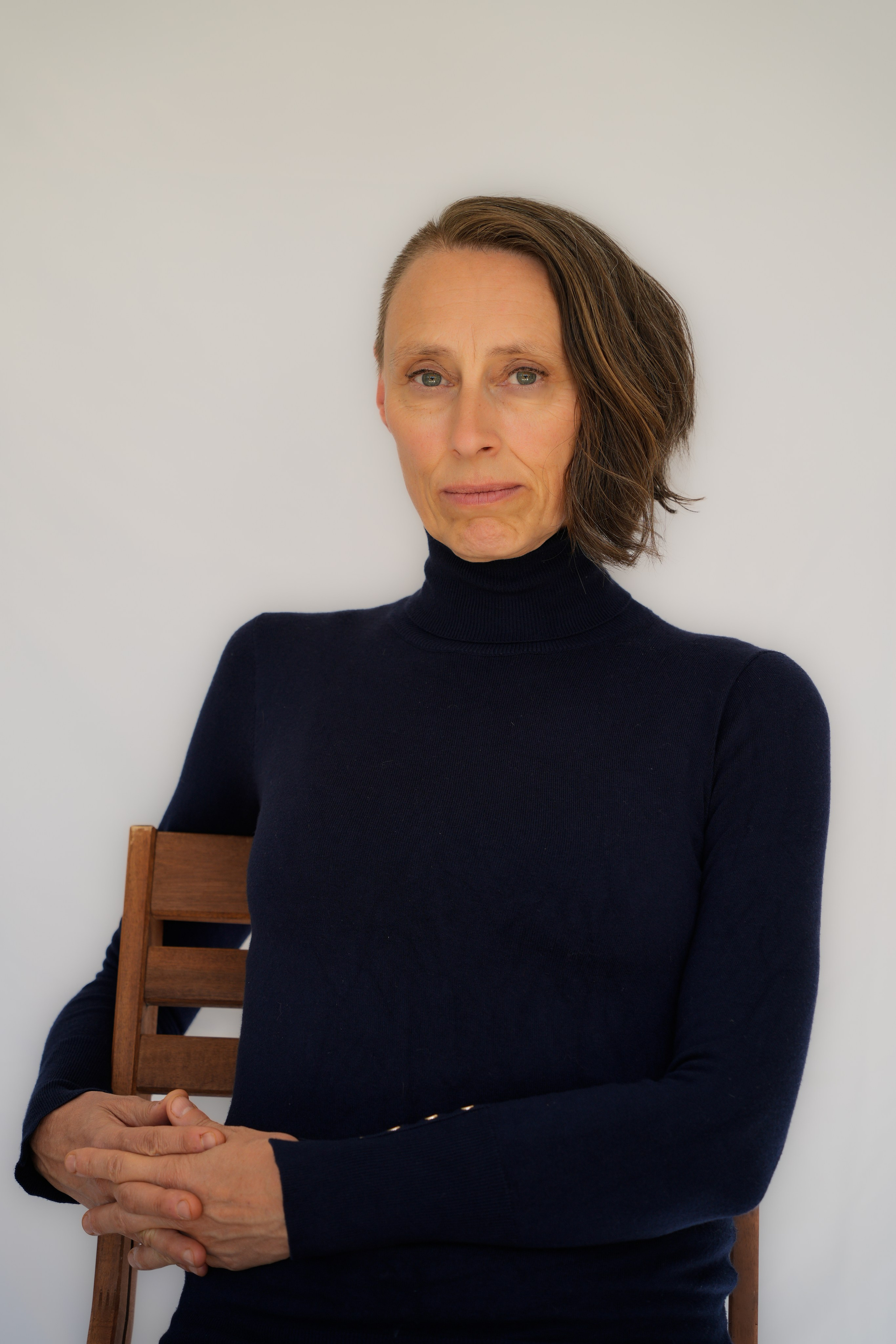 Bright, actor headshot with clean white background, ideal for commercial and advertising roles.