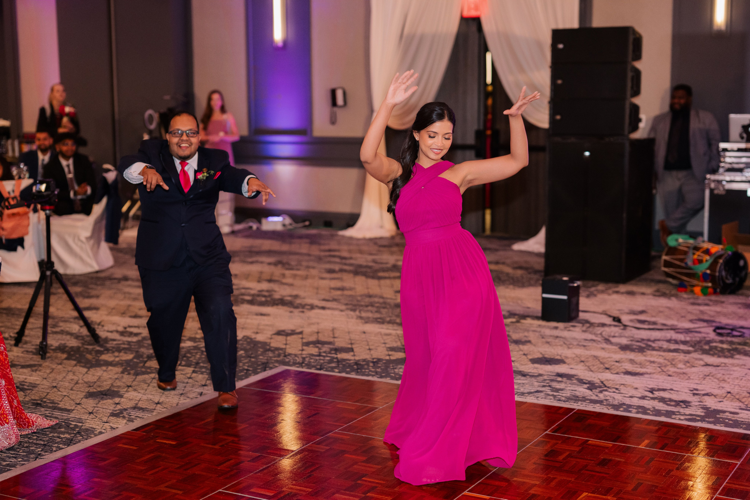 a woman in a pink dress dancing on a dance floor