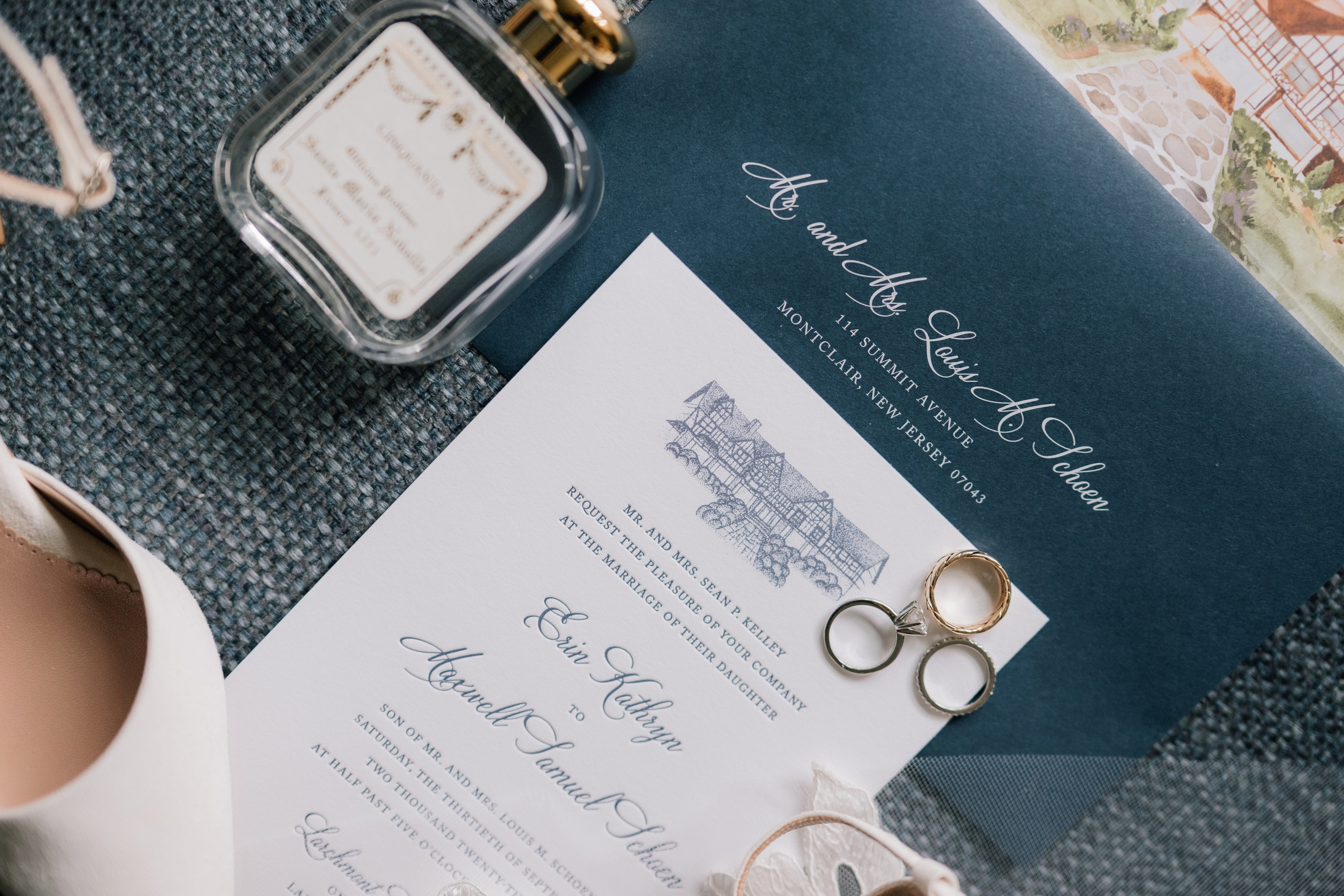 a wedding invitation with a ring and a pair of shoes