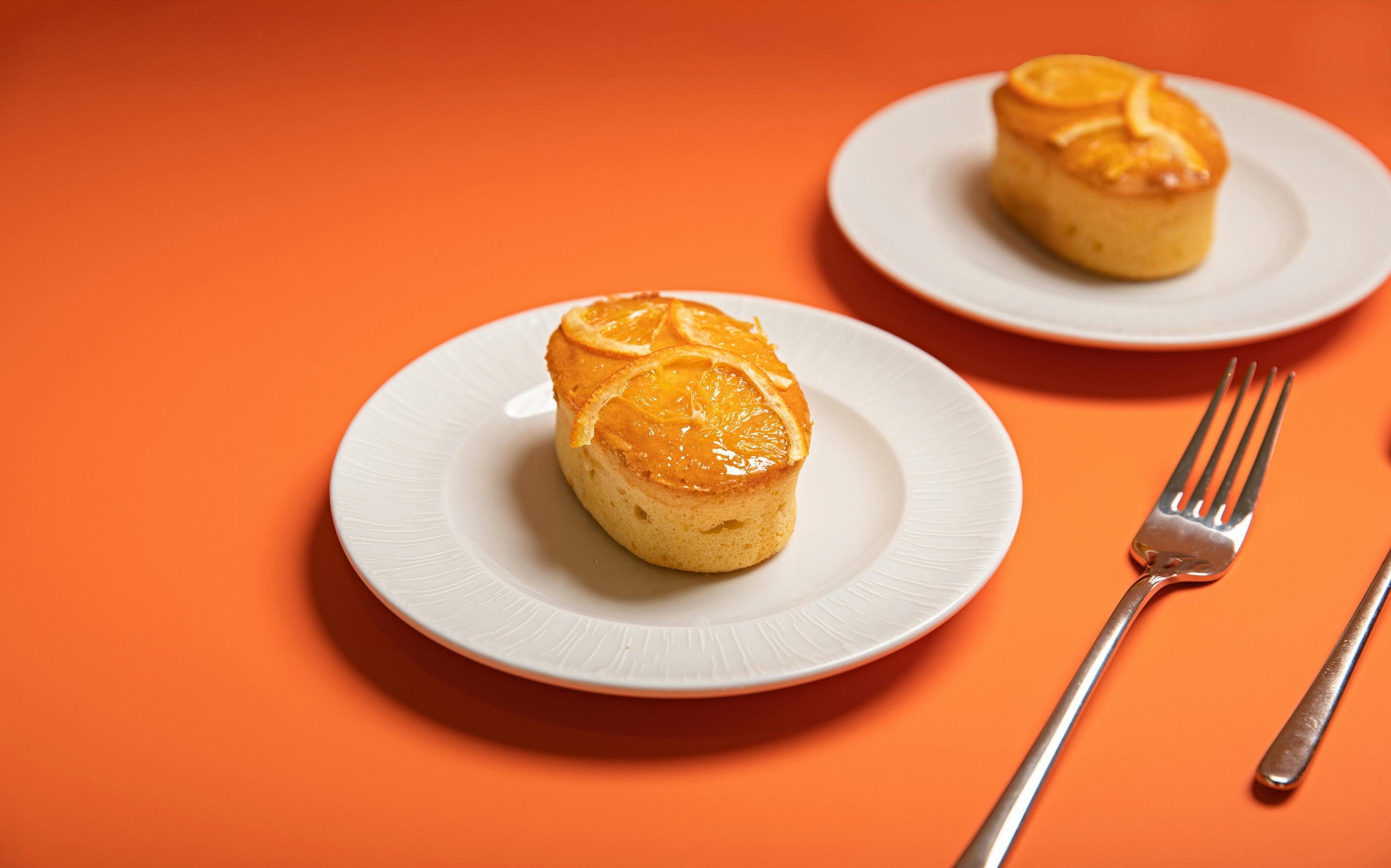 Minimal breakfast food photography of croissants on orange backdrop, photographed by Jay Soundo for café campaign
