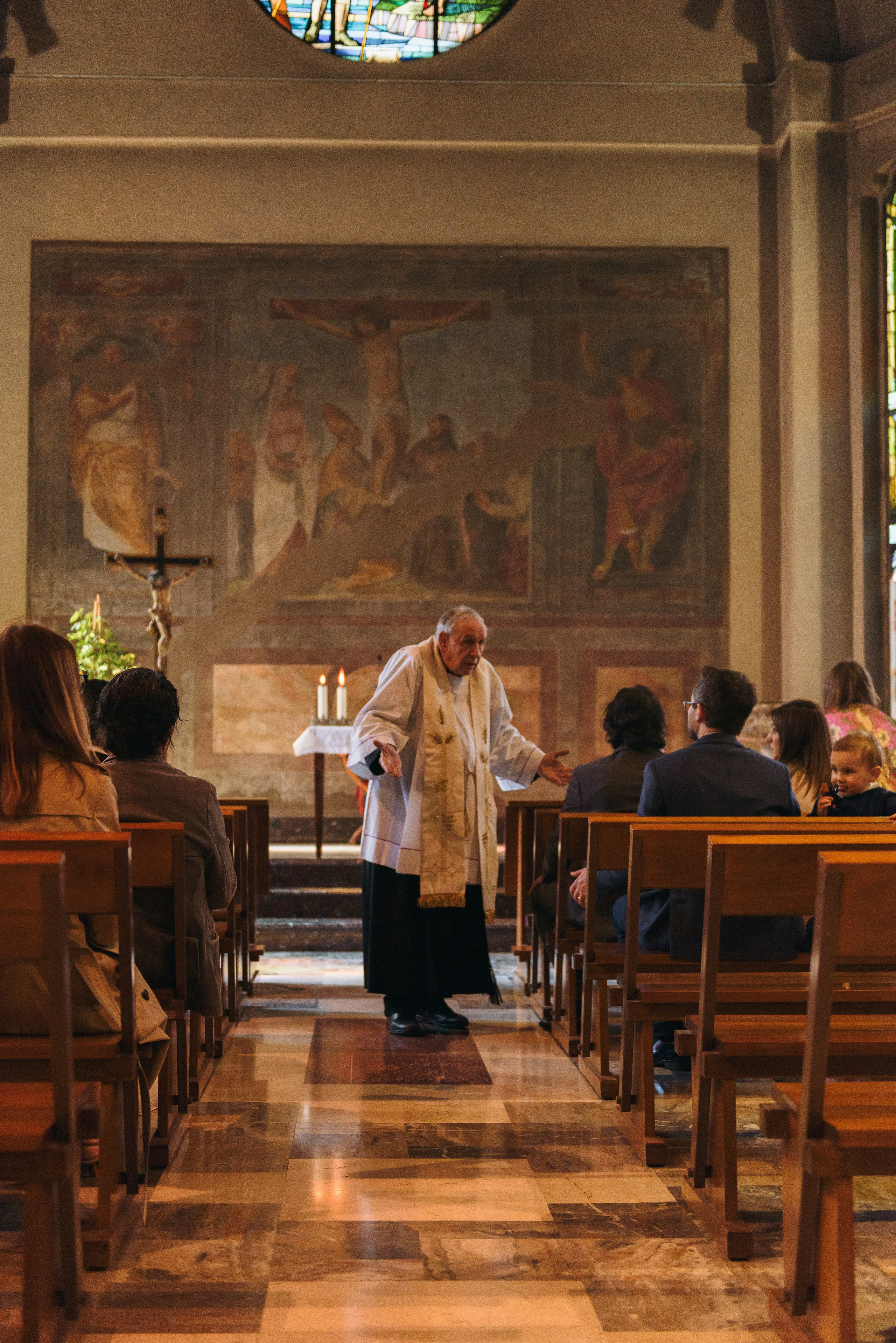 Photographer priest in church in Milan. Baptism Photographer