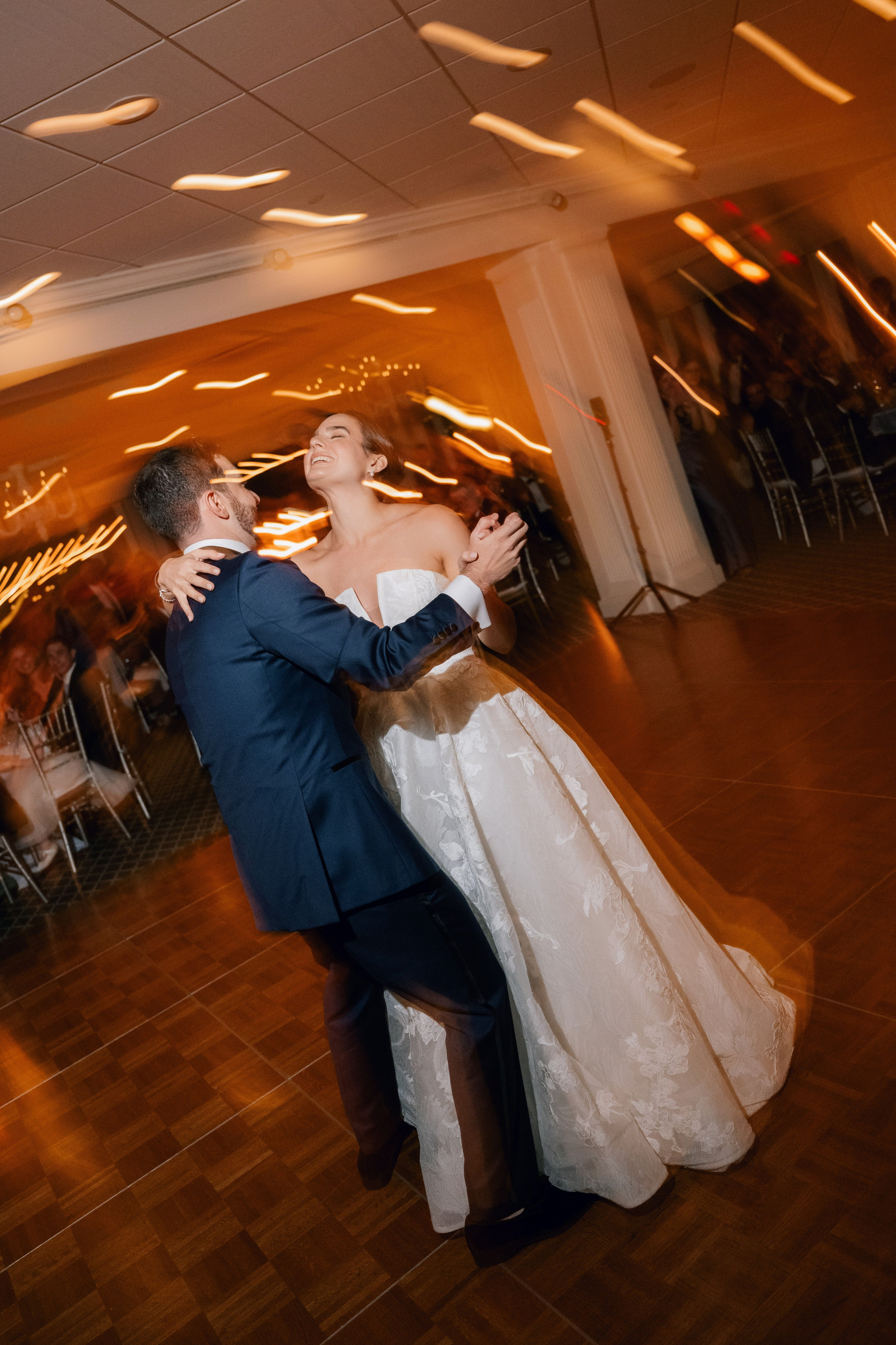 a bride and groom dance together at a wedding reception