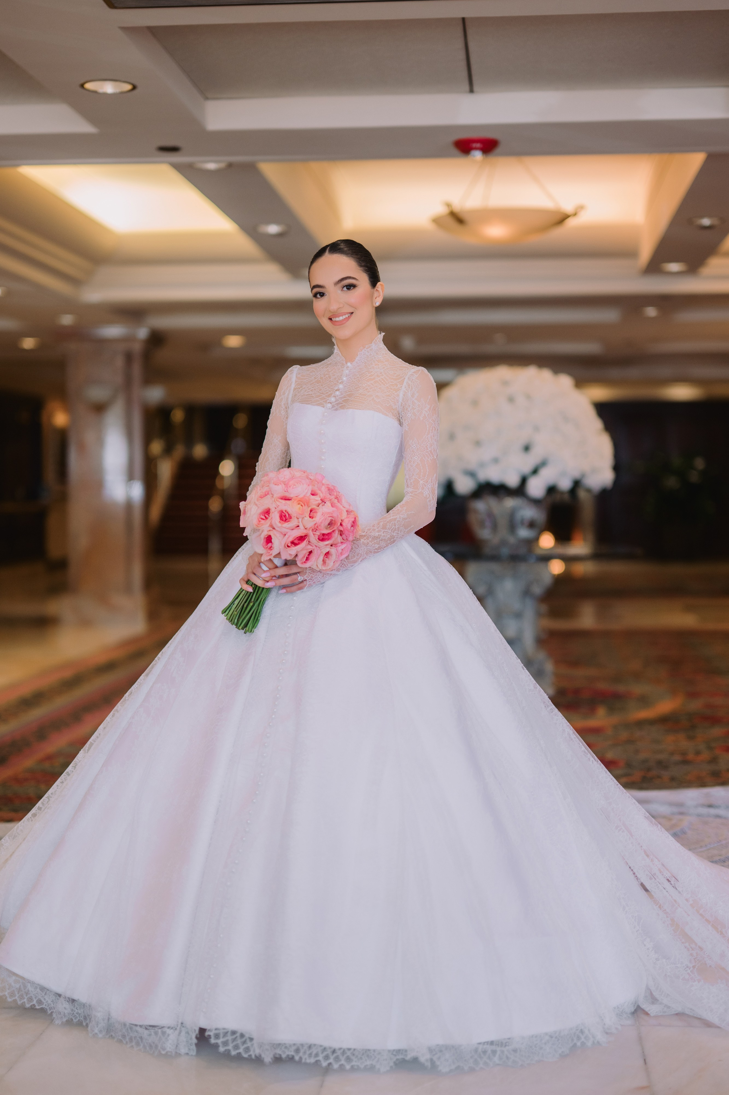 a bride in a white wedding dress holding a bouquet