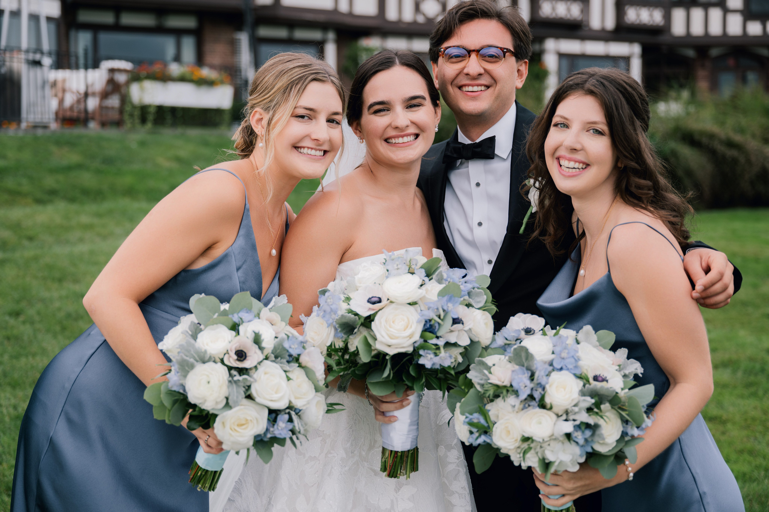 a bride and her bridesmaids pose for a photo