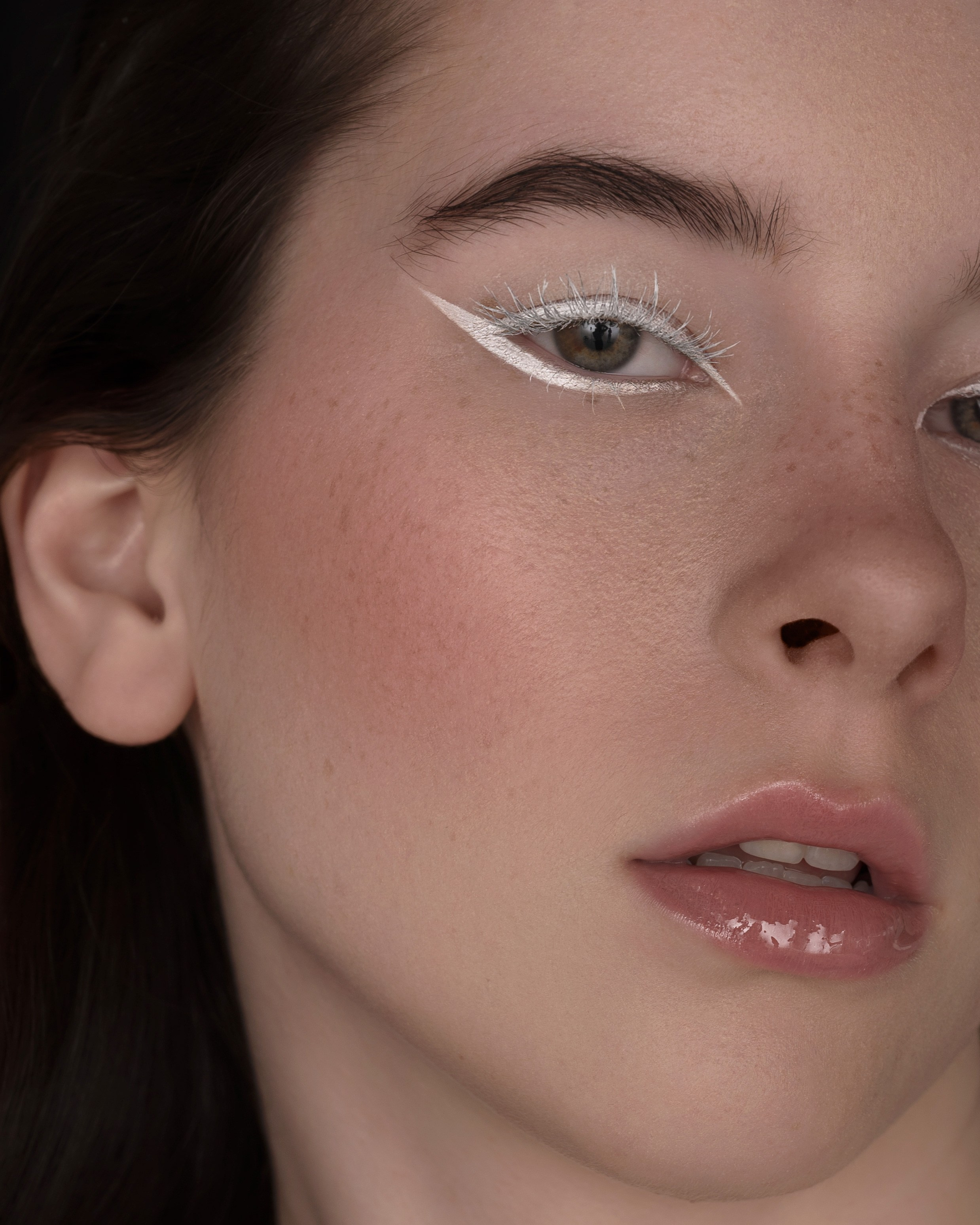 Studio close-up beauty portrait showcasing intricate eyeliner and flawless foundation with professional retouching, in San Francisco.
