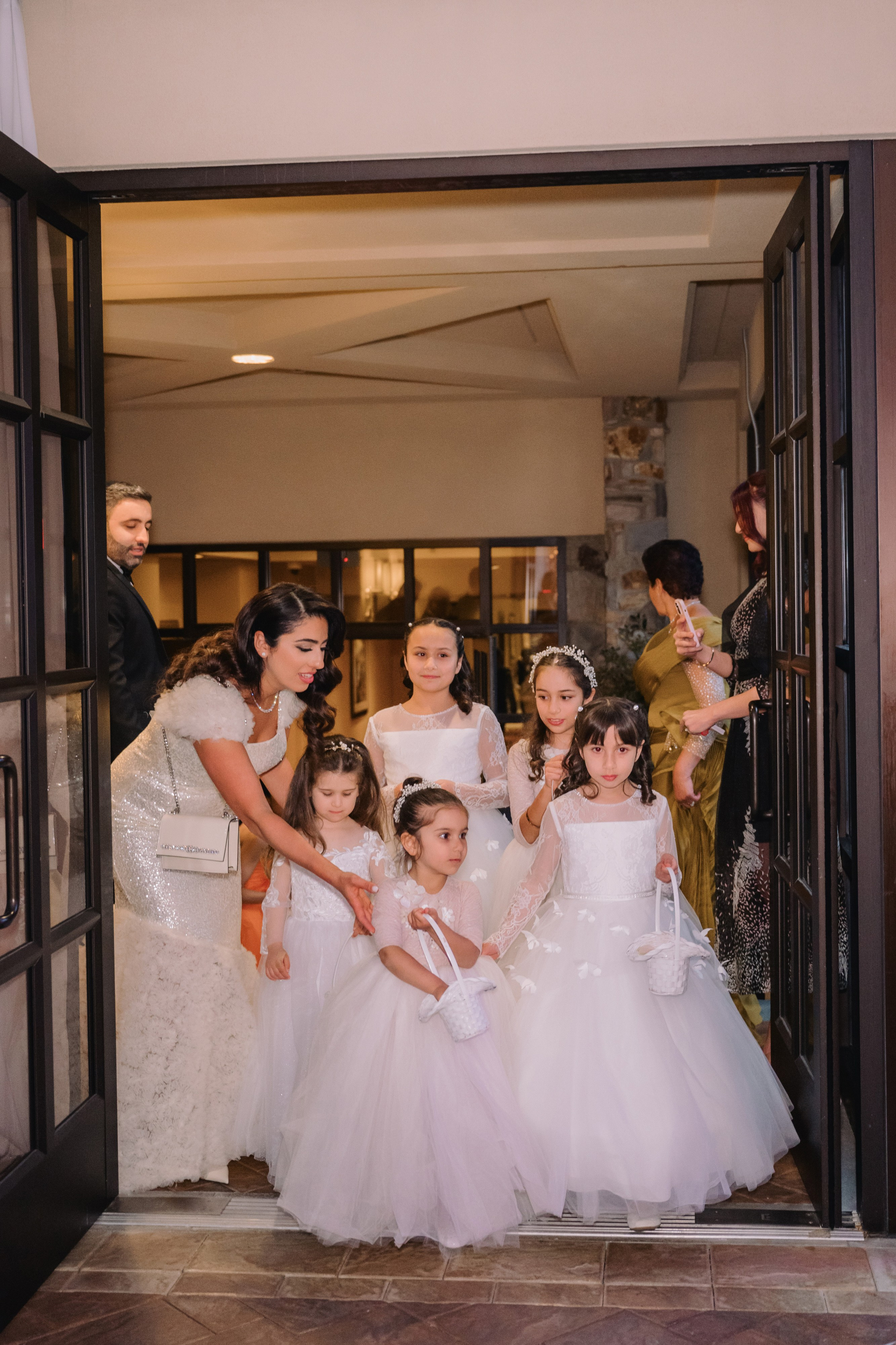 a bride and her flower girls are getting ready for their wedding