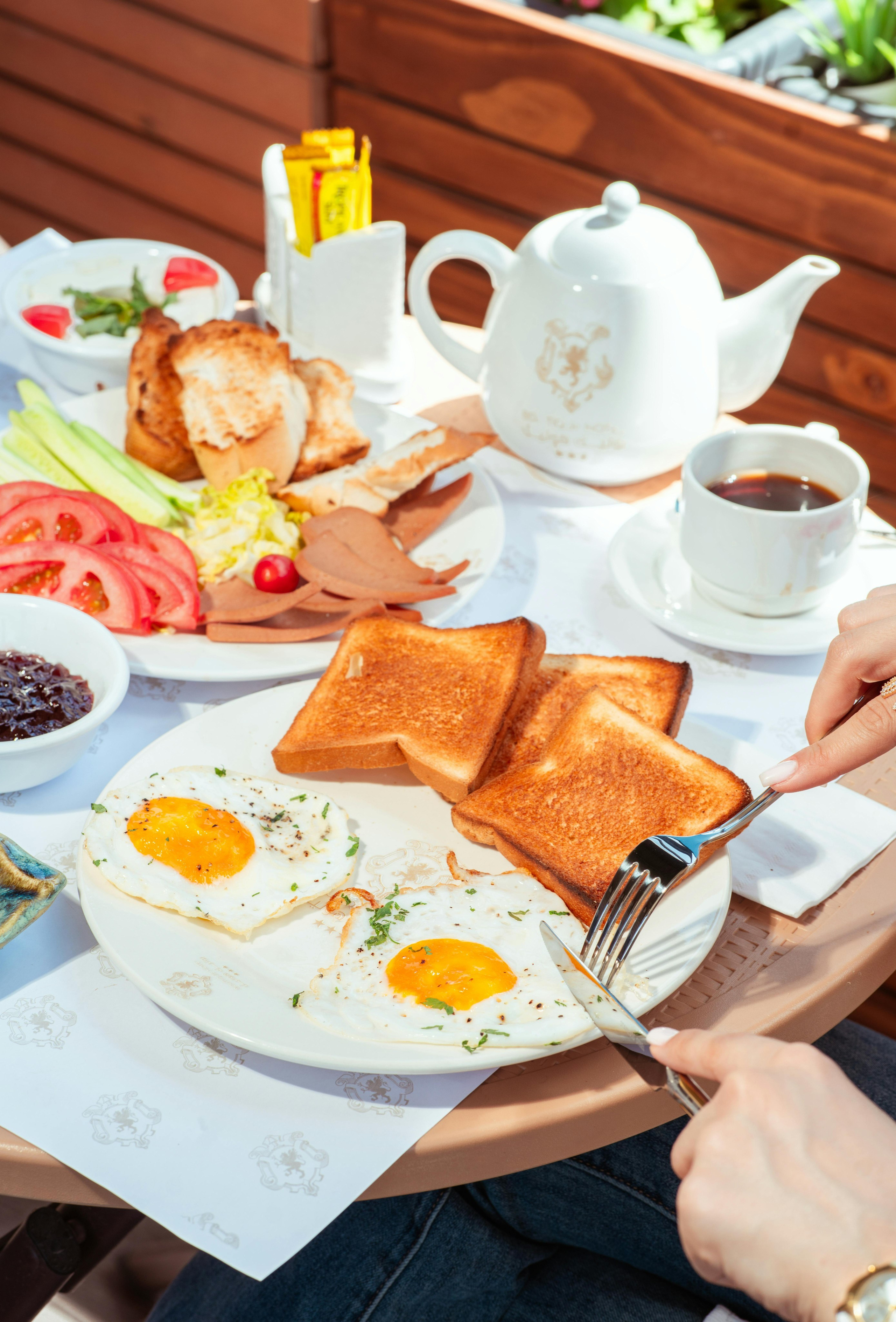 Editorial food photography of breakfast table with pastries, fruit, and tea, photographed by Jay Soundo for restaurant and café branding