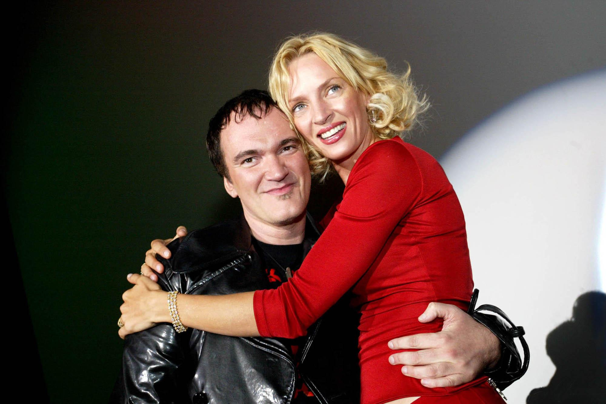 American film director Quentin Tarantino and actress Uma Thurman embrace while under the spotlight during a promotional tour in Berlin Germany.
