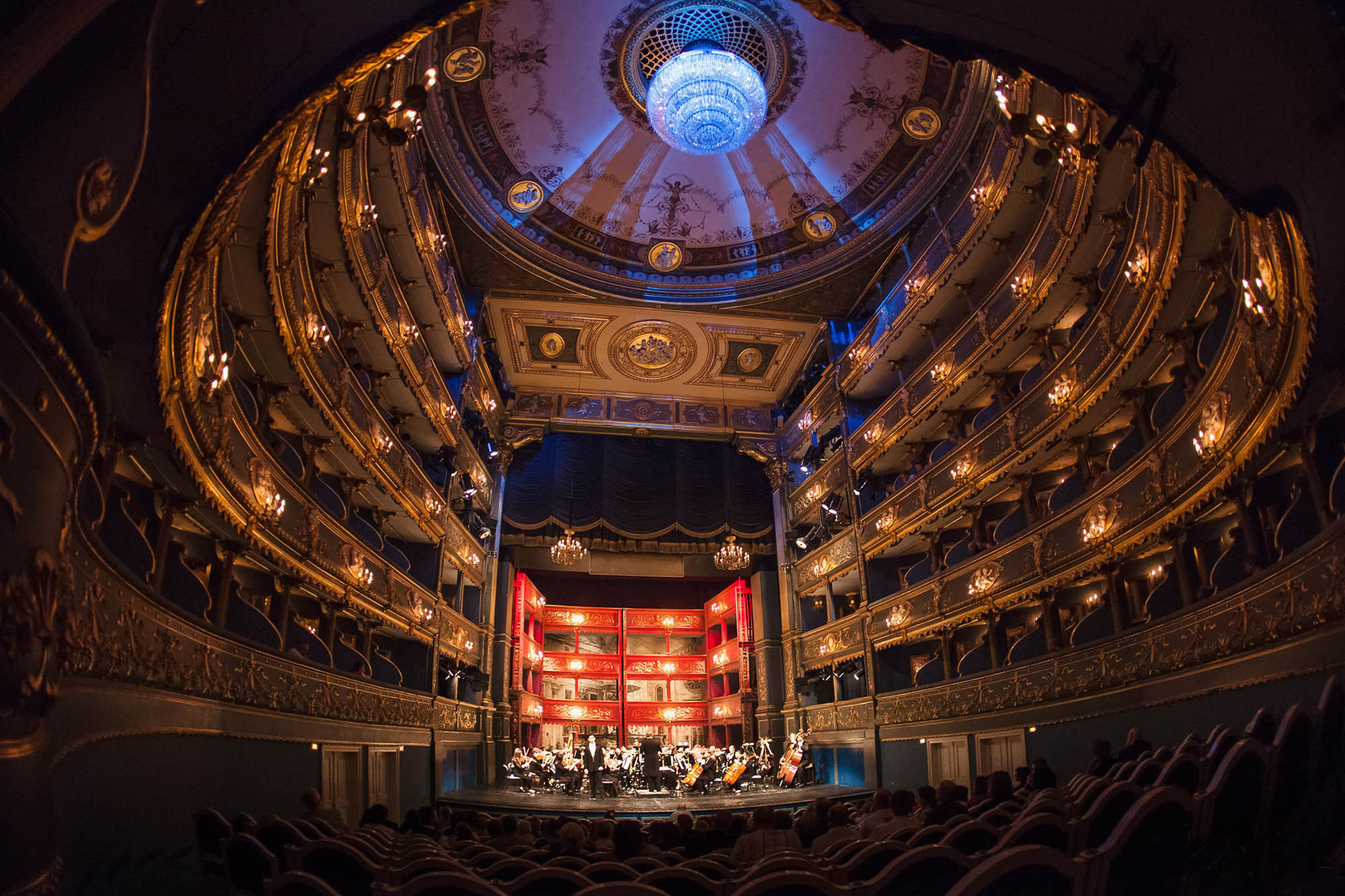 A fish eye view of the Estates Theatre captured during a live performance.