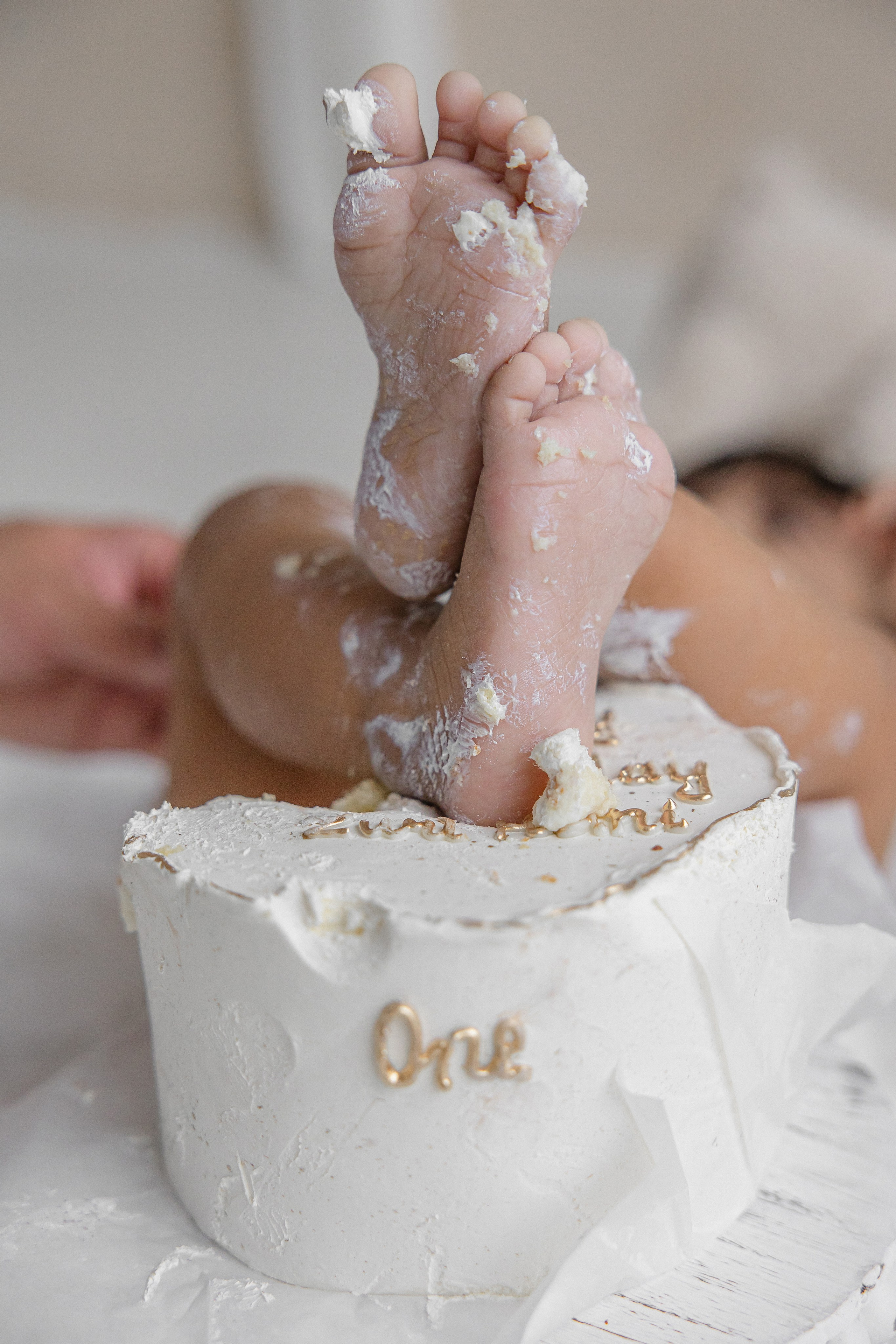 Adorable baby with cake-covered hands