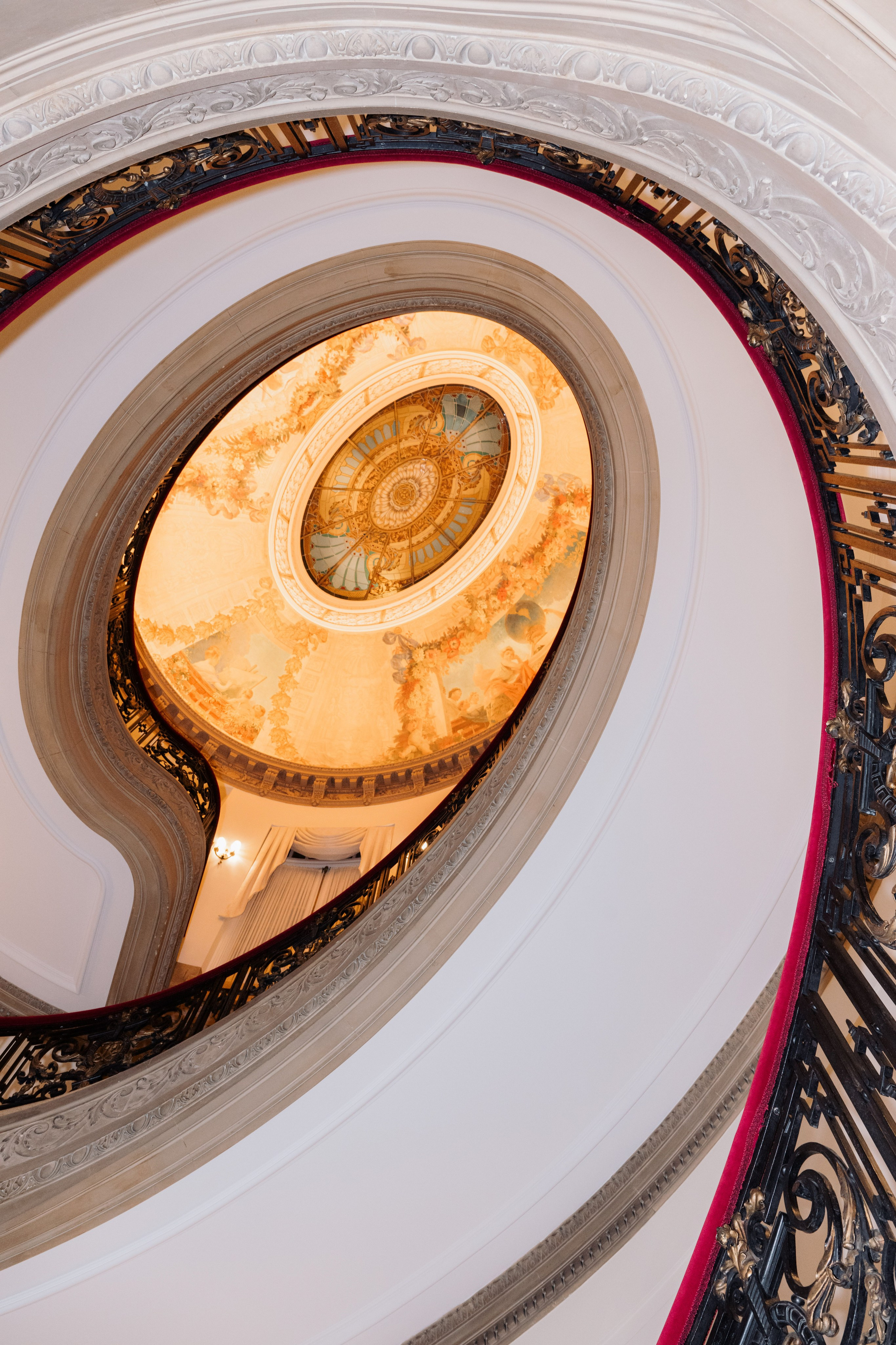 a circular staircase with a clock on the top