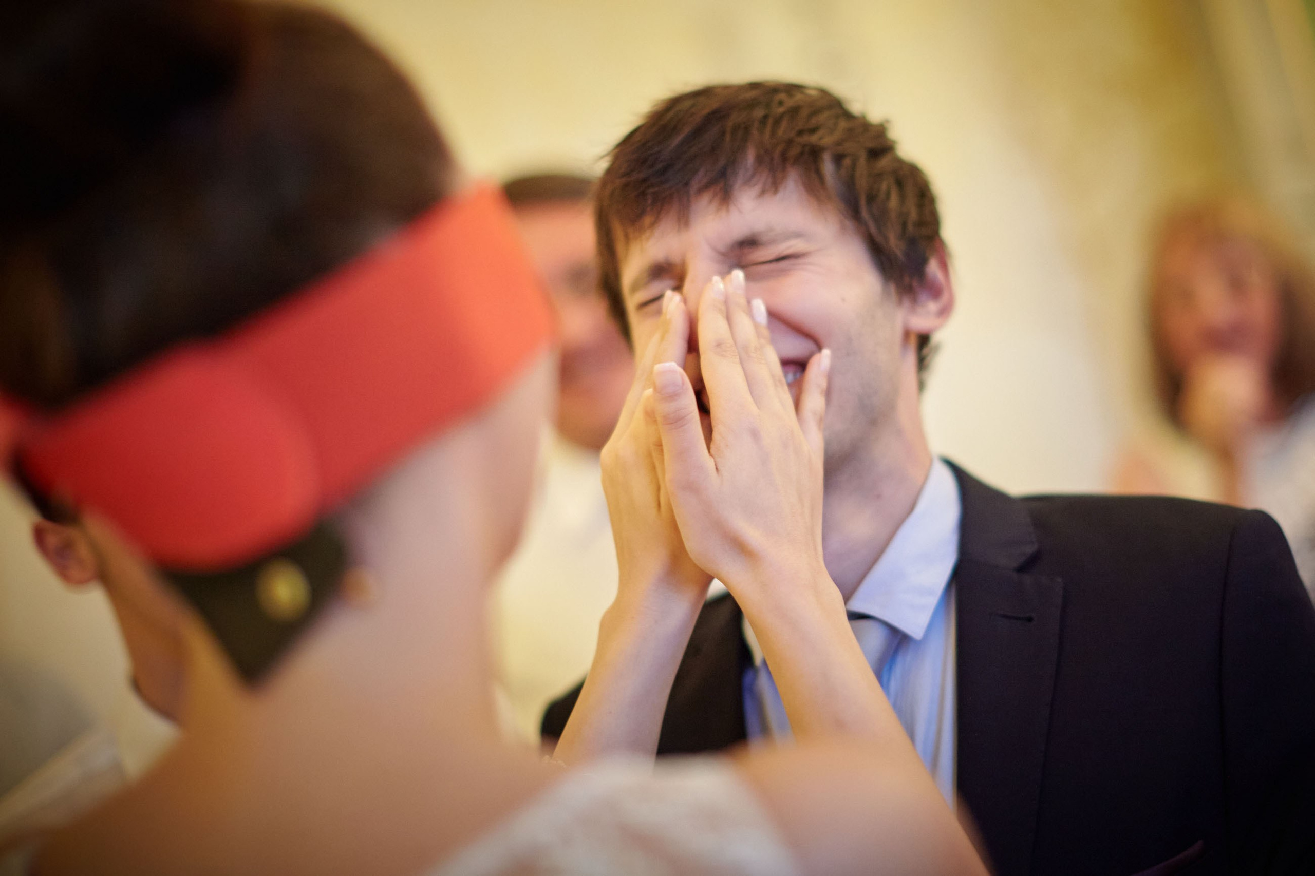 A blindfolded bride amusingly struggles to locate her groom by relying solely on touch in a playful wedding game.