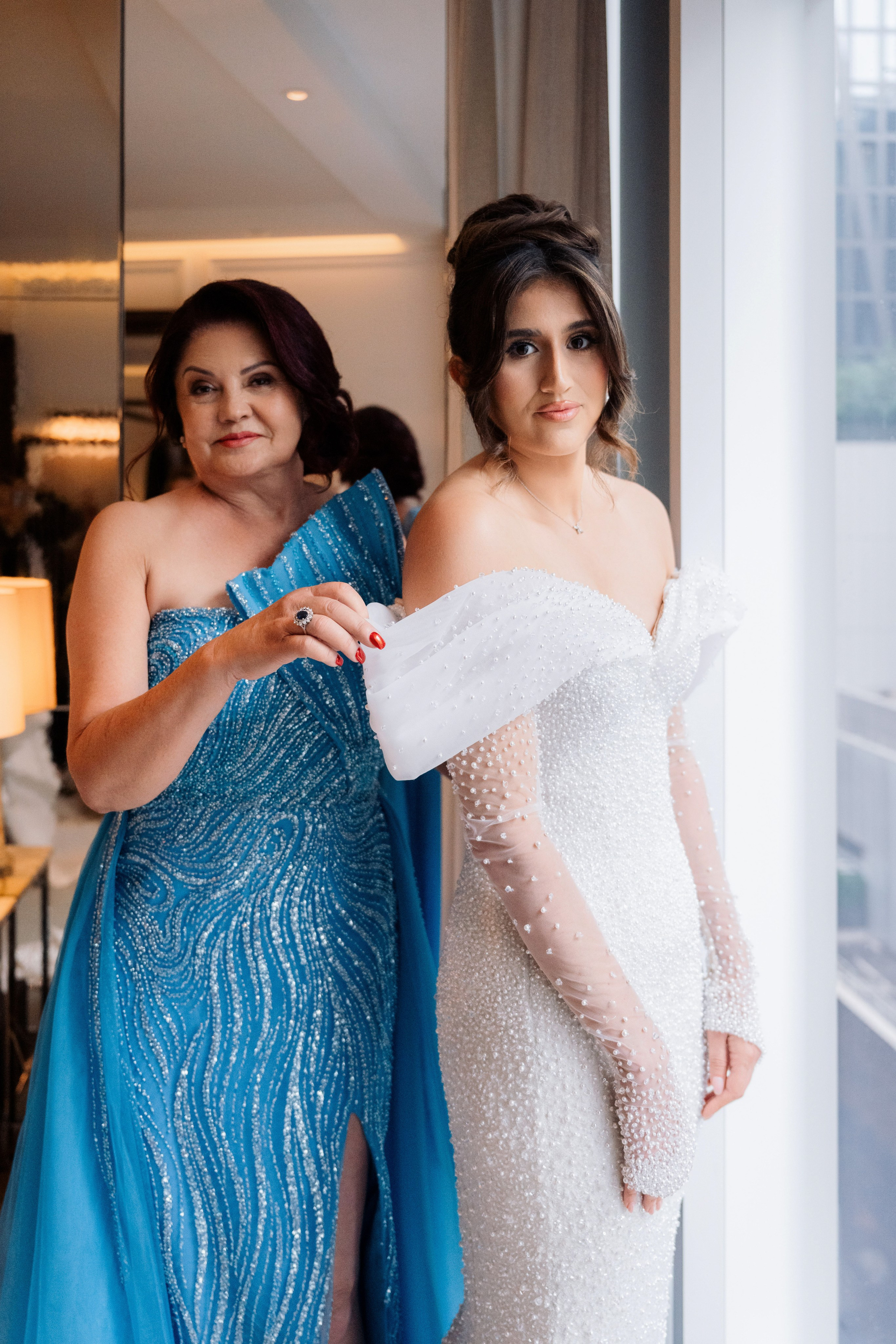 two women in dresses standing next to each other women