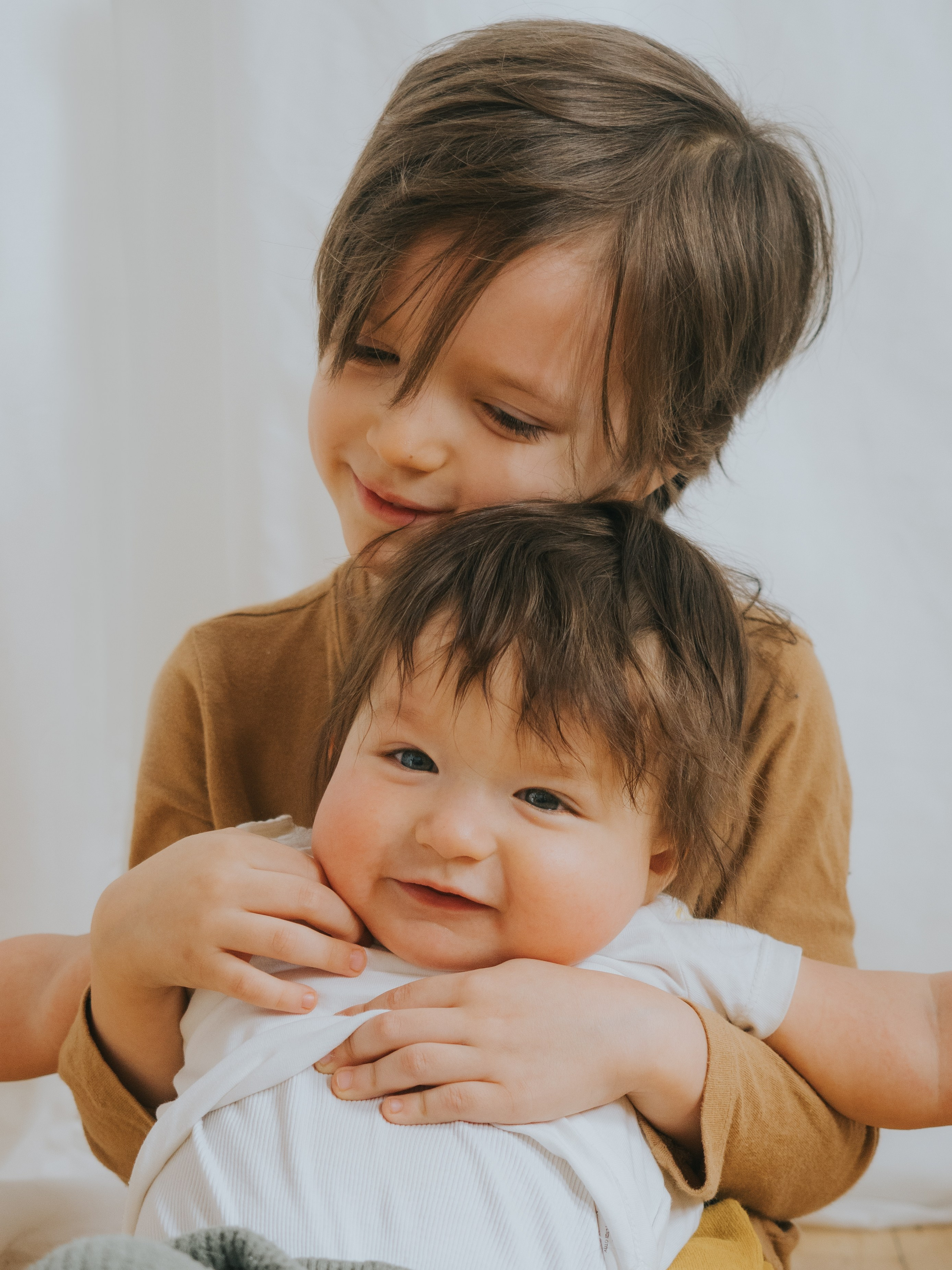 Two brothers snuggling.