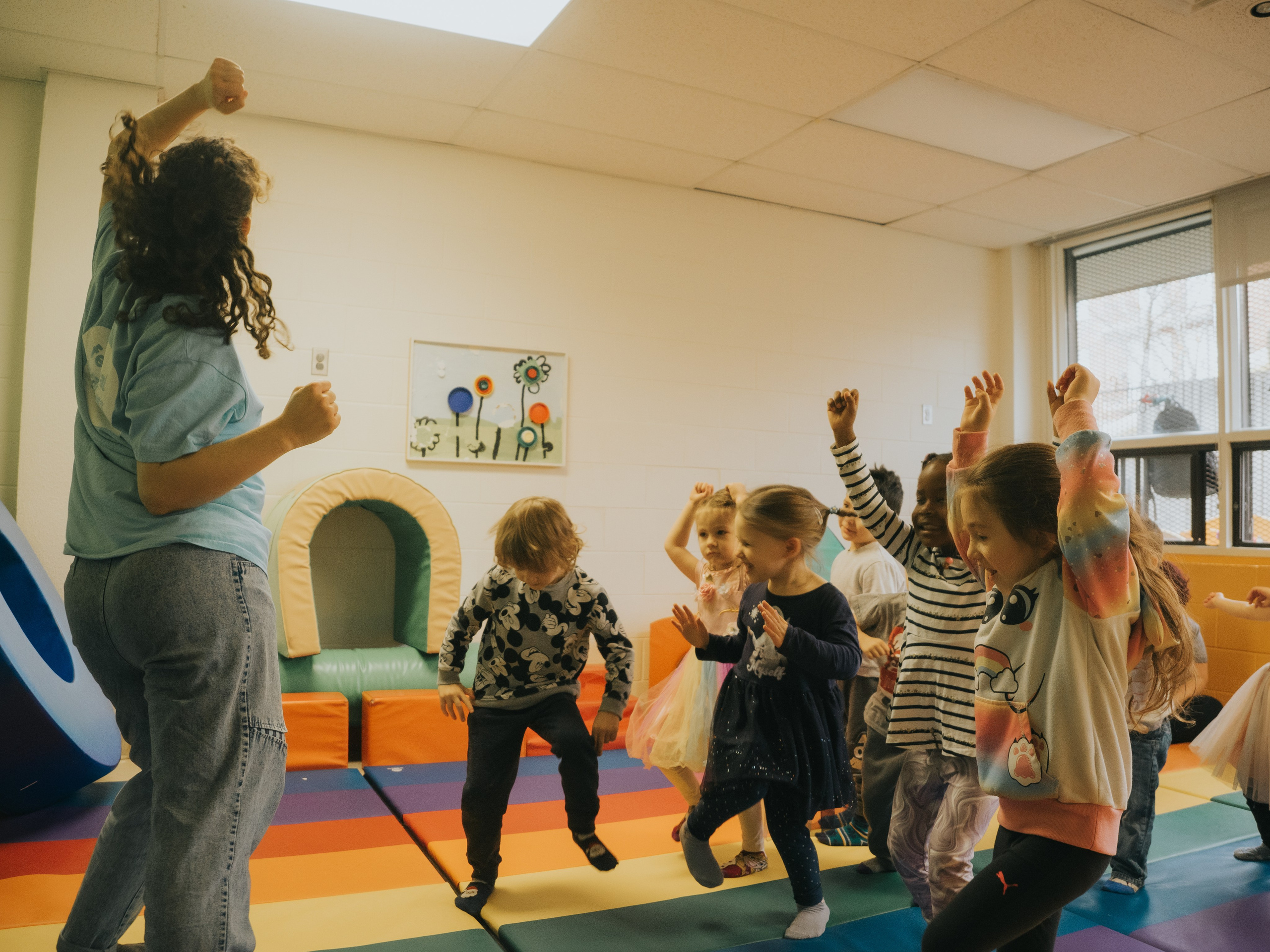 Children throwing hands in air.