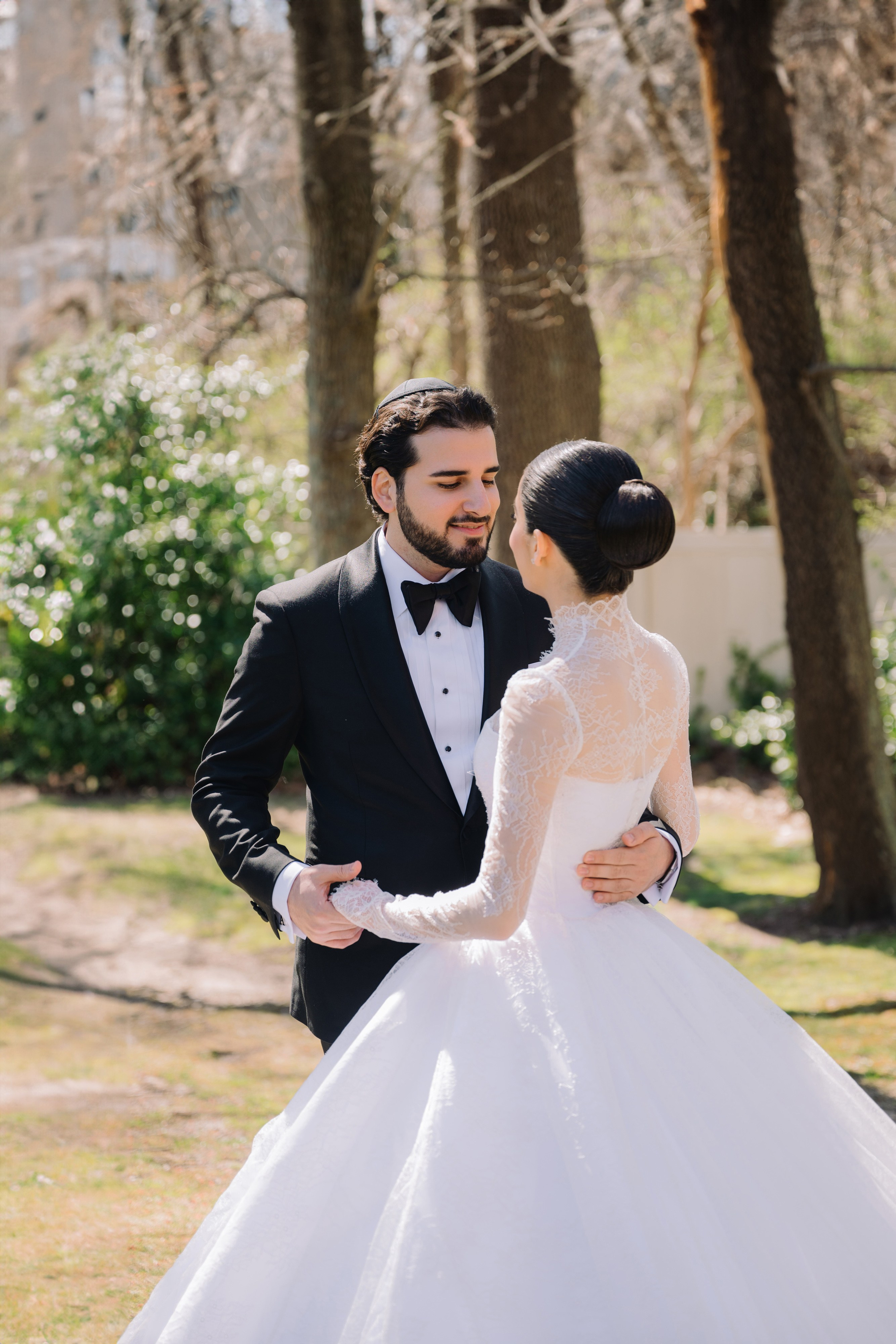 a bride and groom pose for a photo in the garden