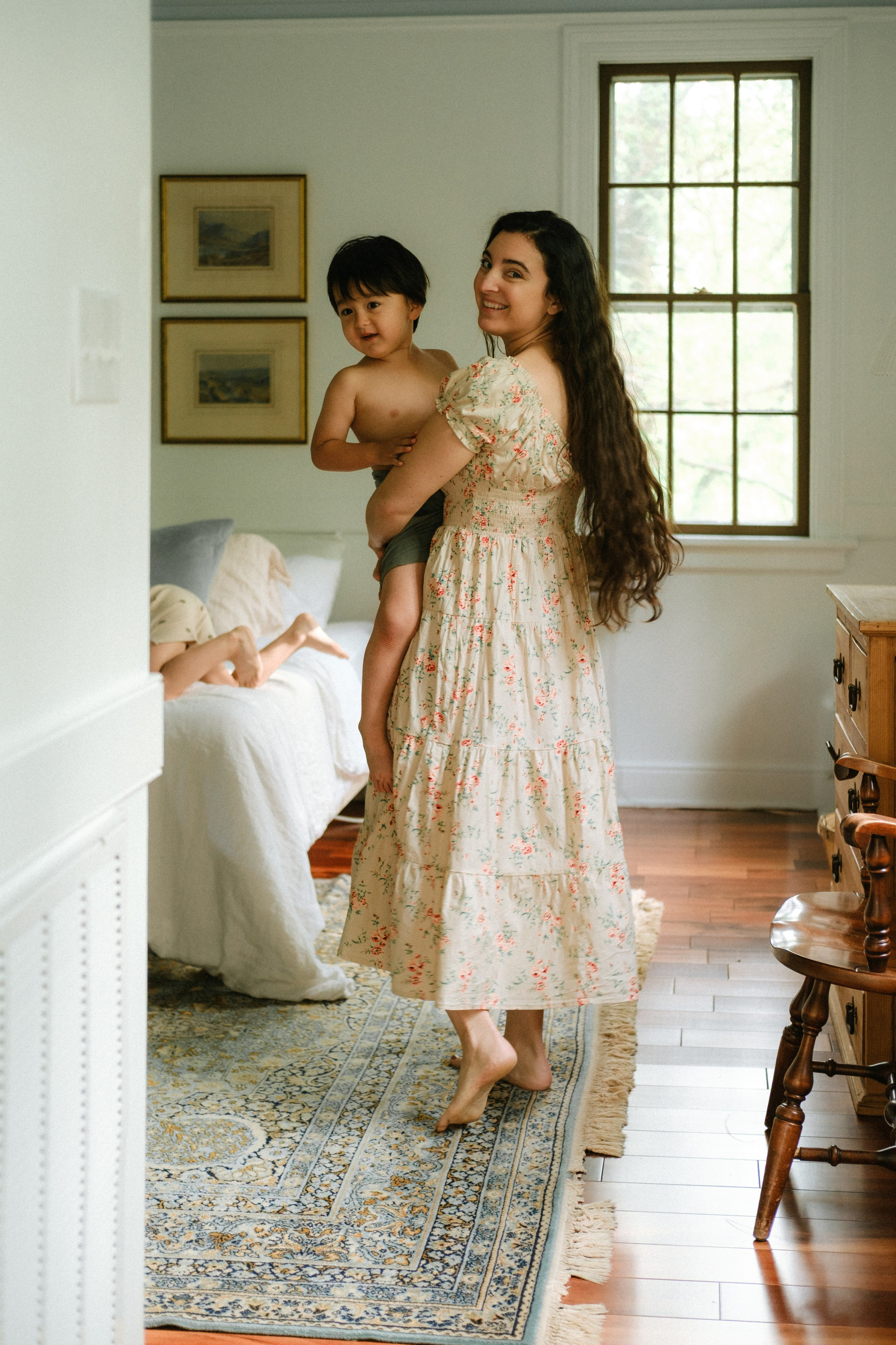 Mom holding her son in her arms in their bedrom in Richmond, VA