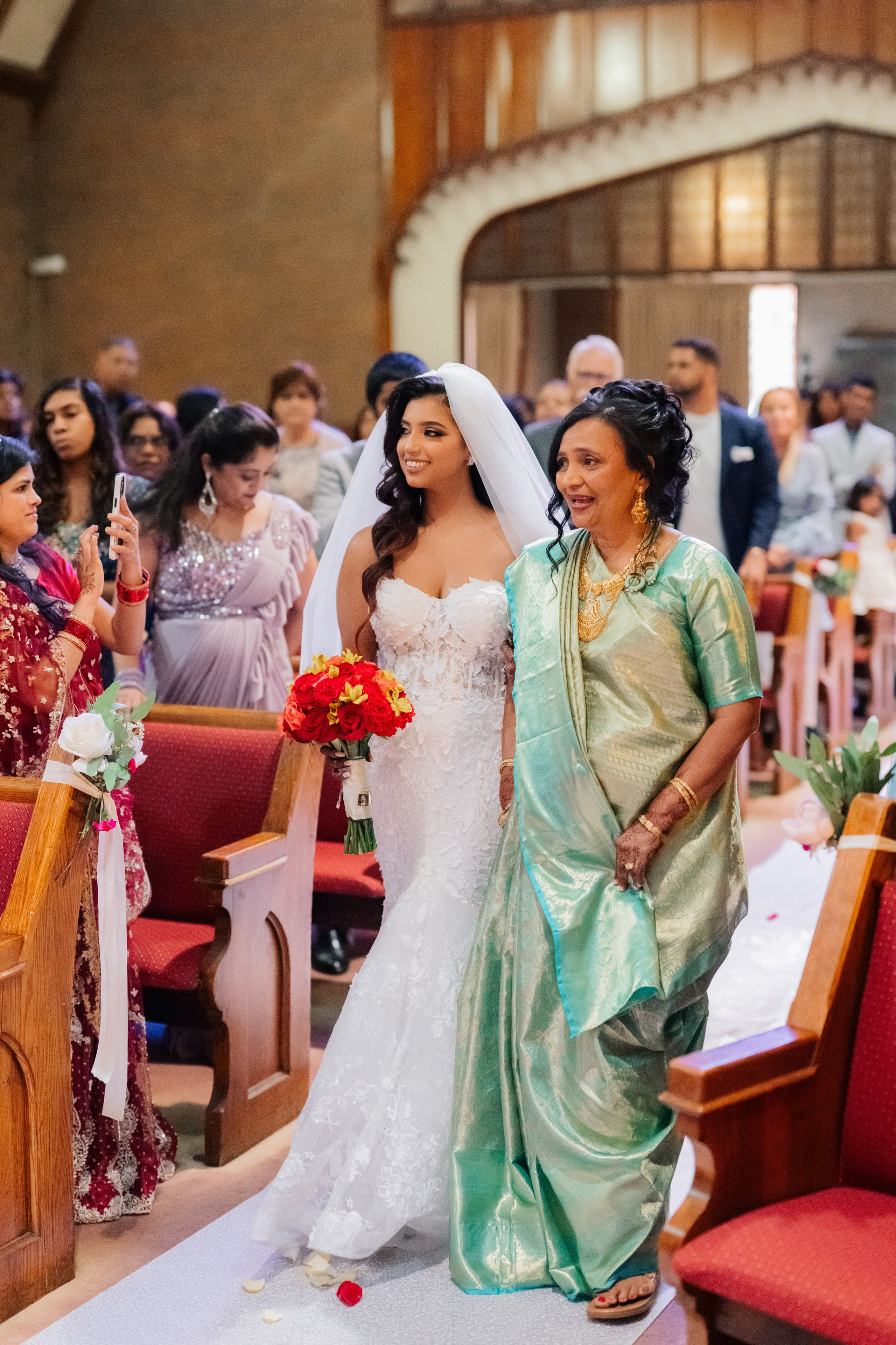 a bride and her mother walking down the aisle