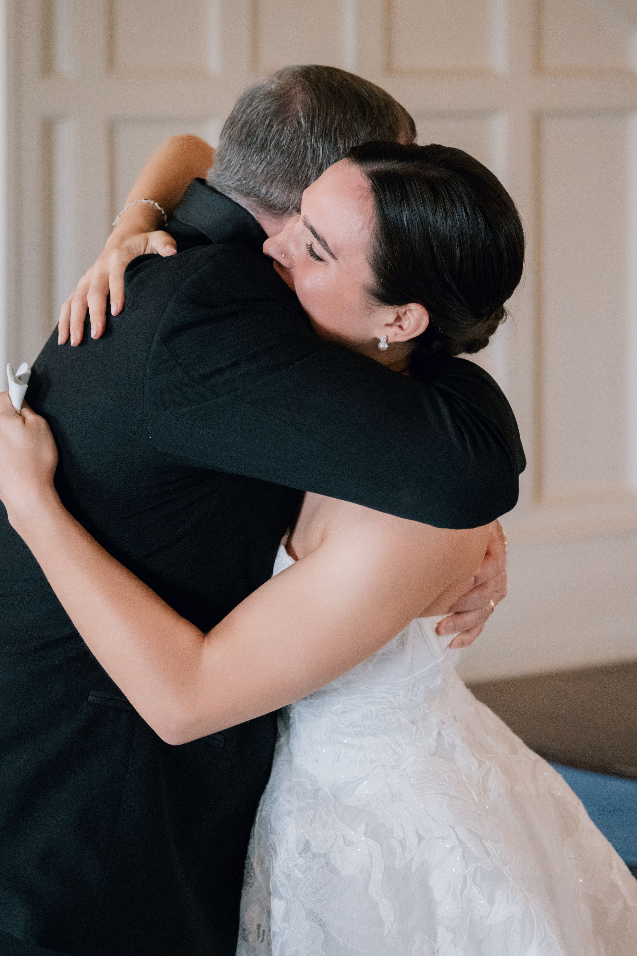 a bride and groom hug each after their wedding ceremony