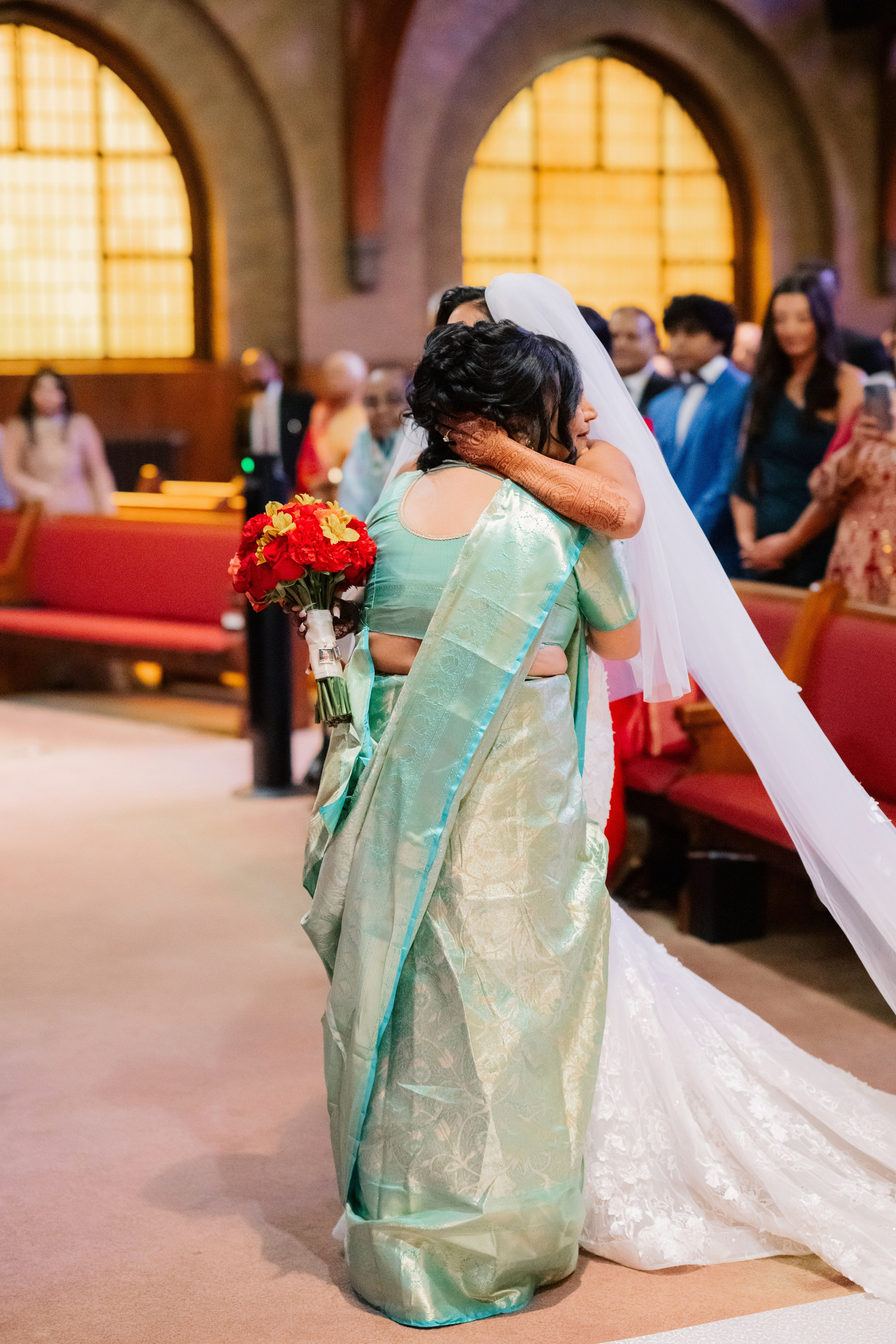 a woman in a wedding dress is walking down the aisle