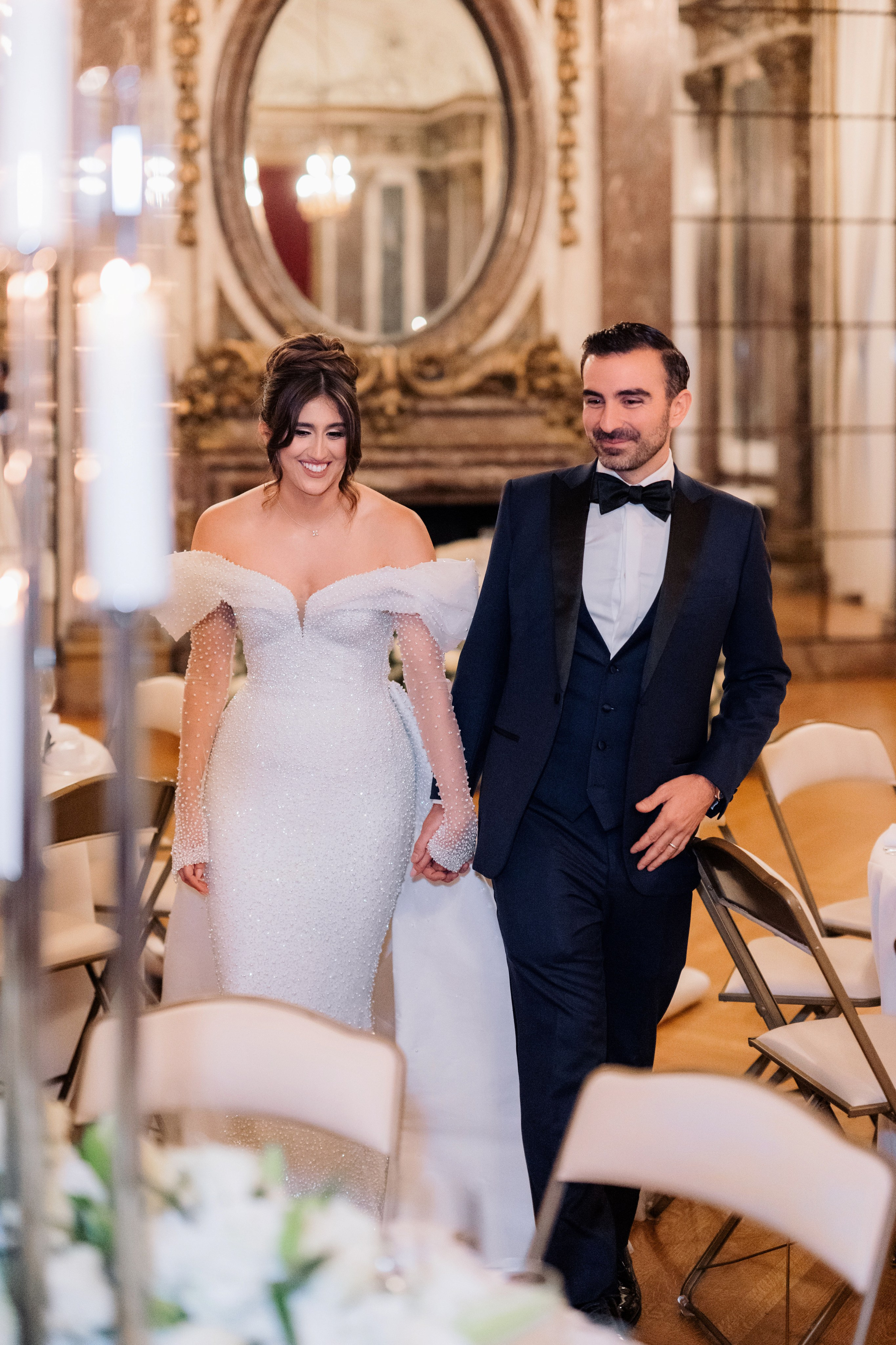 a bride and groom walking down the aisle