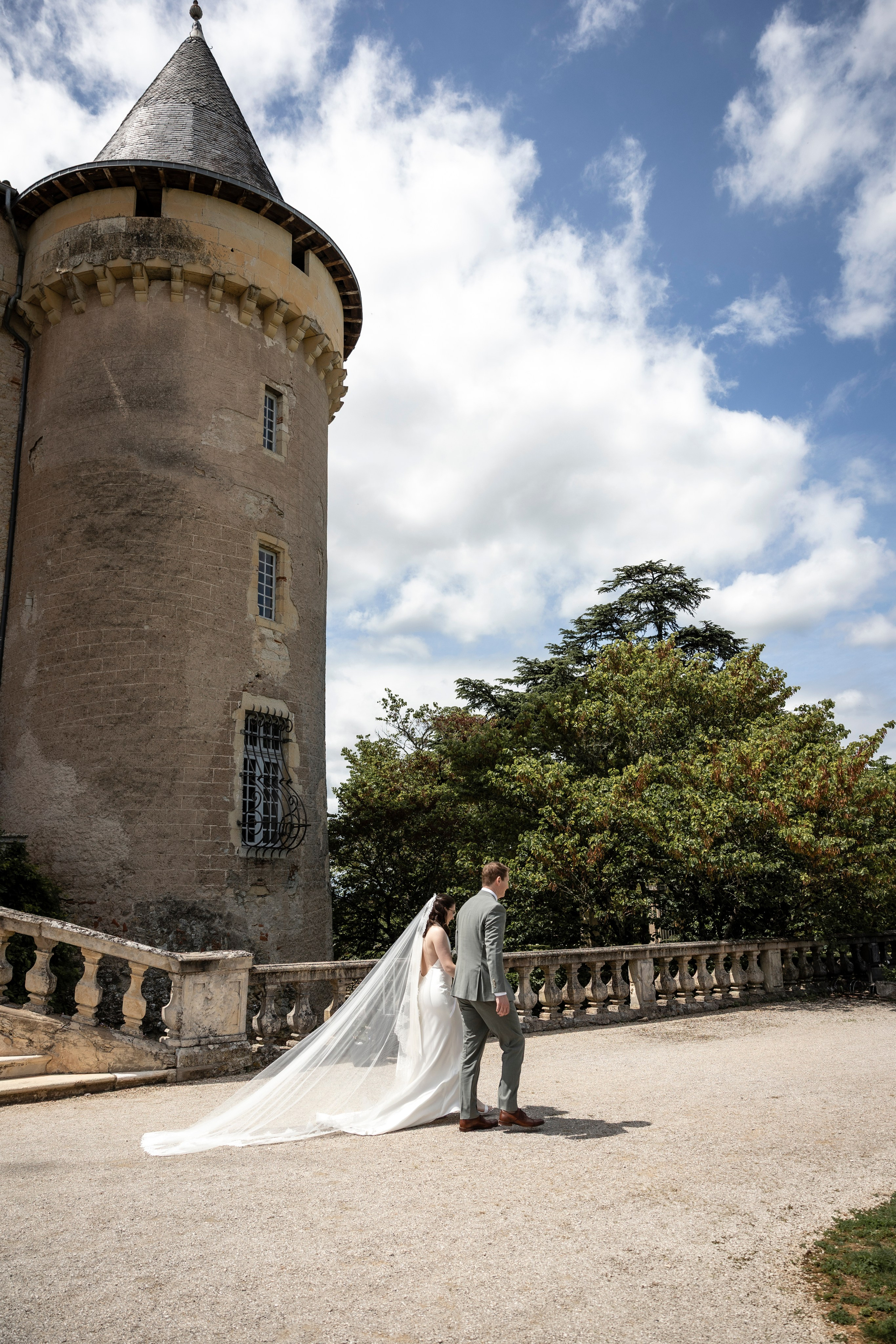Bride and groom walking through the château grounds at Château Mercuès