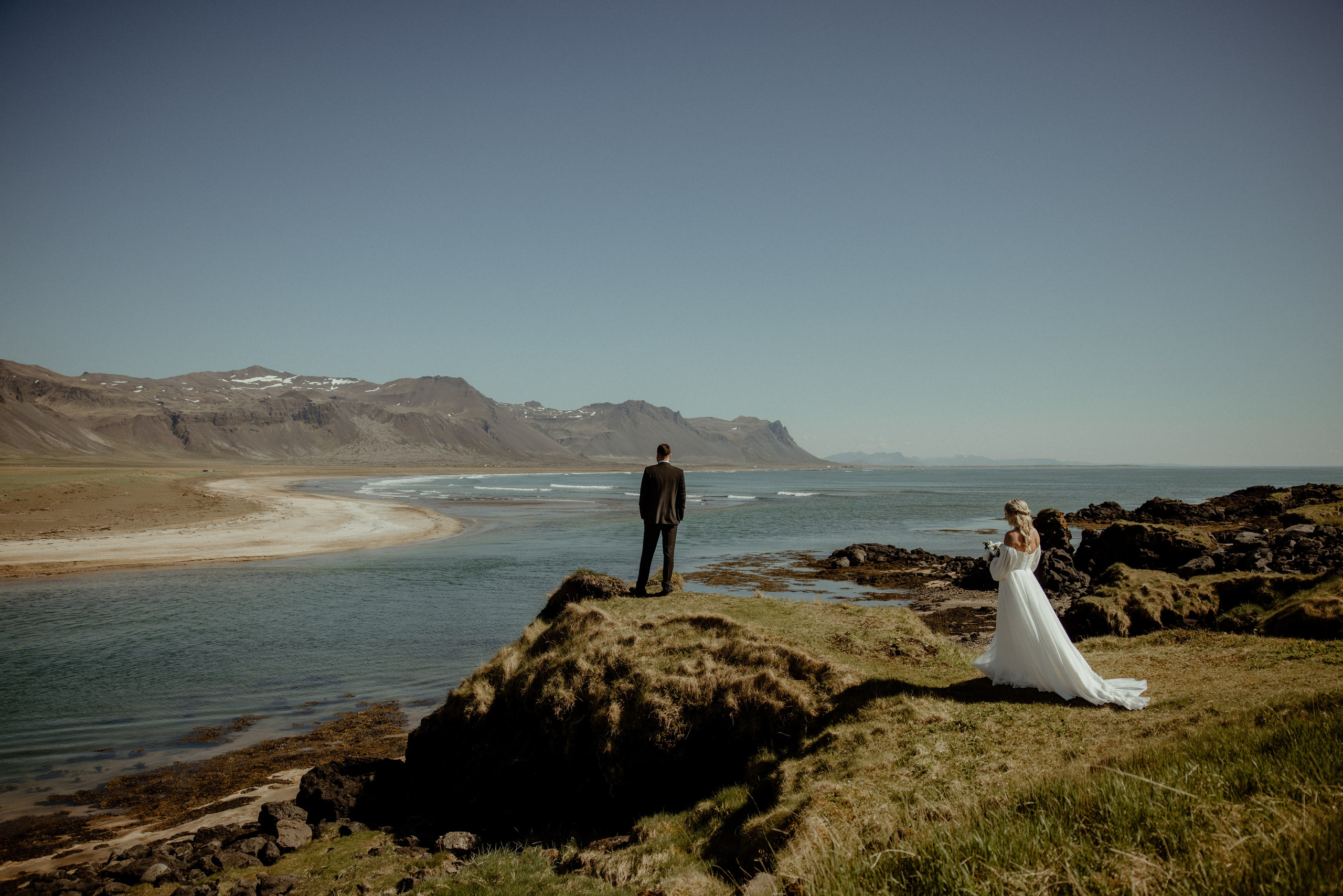 Iceland elopement at Budir with midnight sun wedding photos at black sand beach. Iceland elopement photographer & videographer