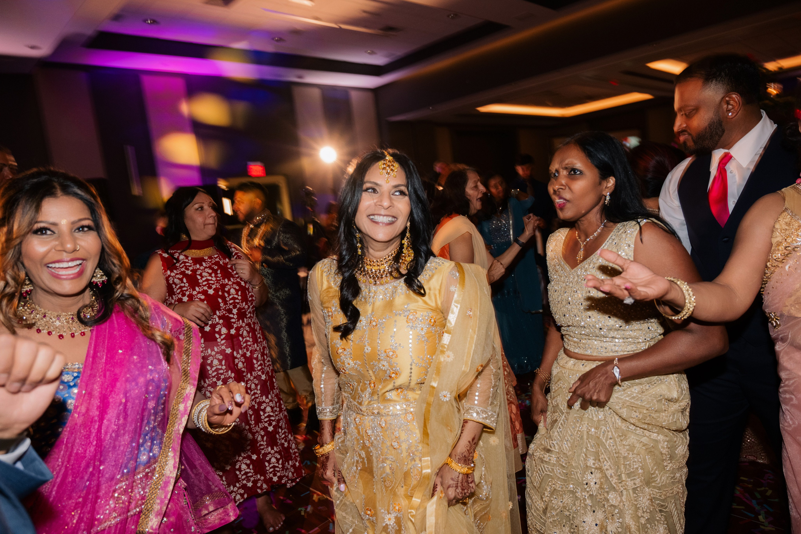 a group of people dancing at a wedding