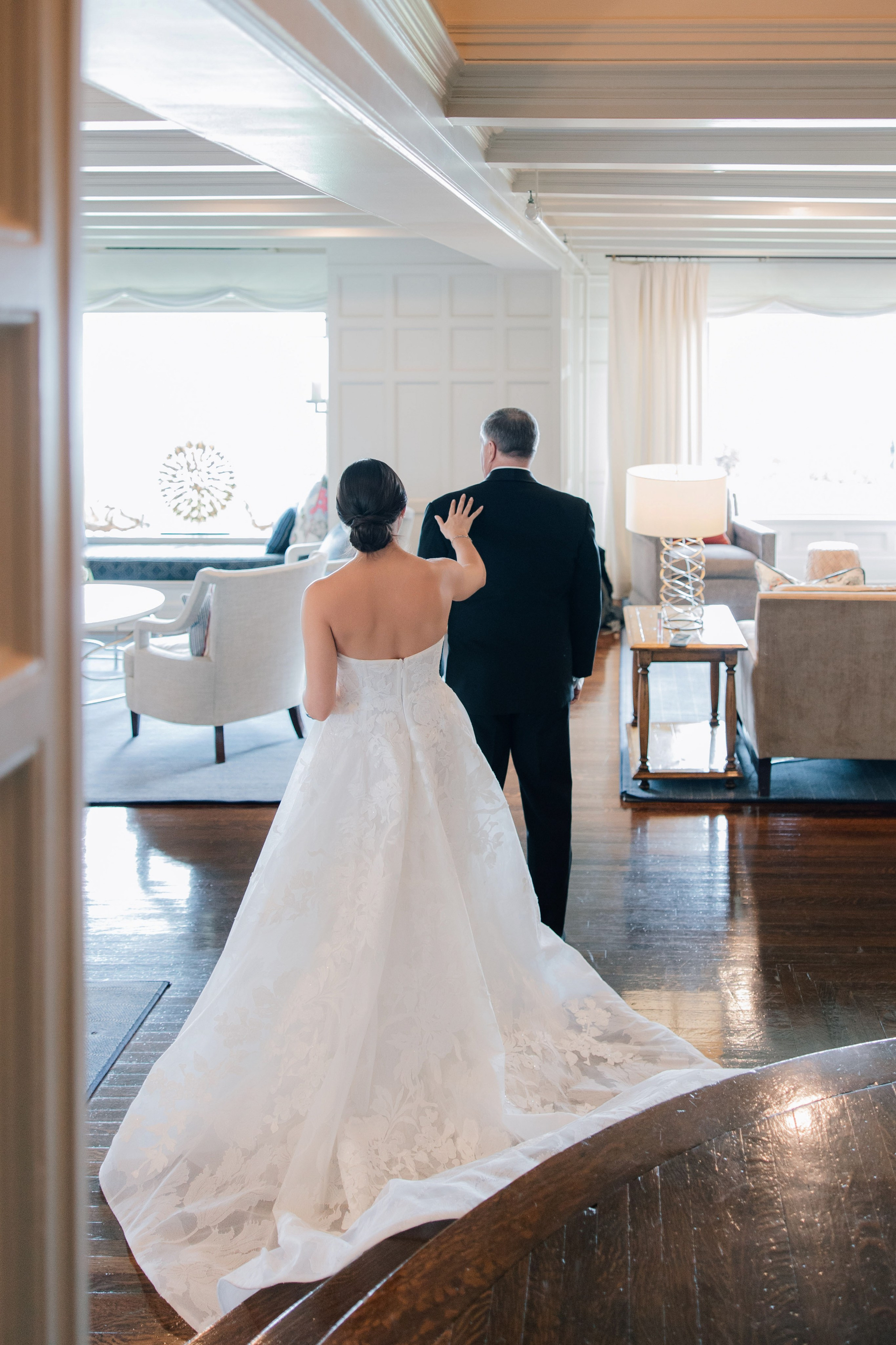 a bride and groom walking through a living room
