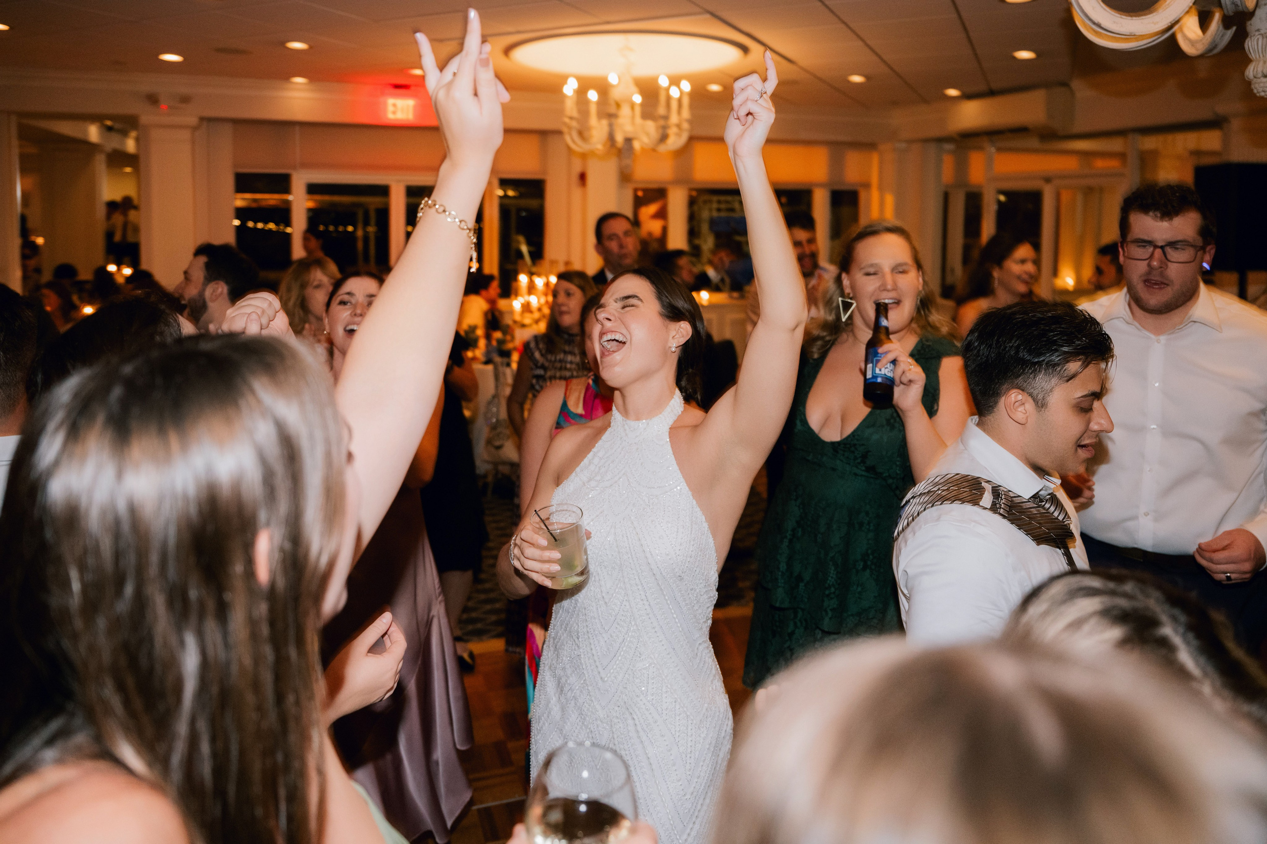 a group of people dancing at a wedding
