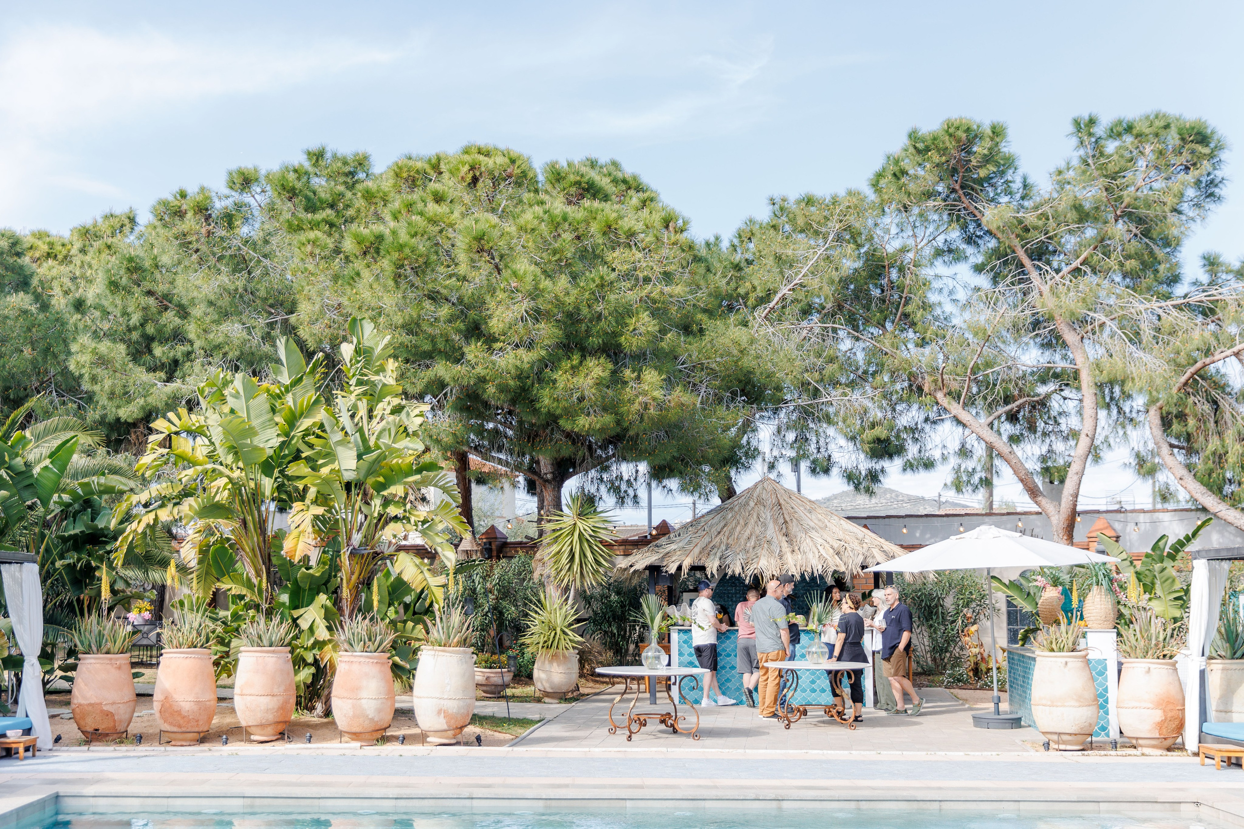 A group of guests are enjoying the rehearsal party at Gran Villa Rosa wedding venue