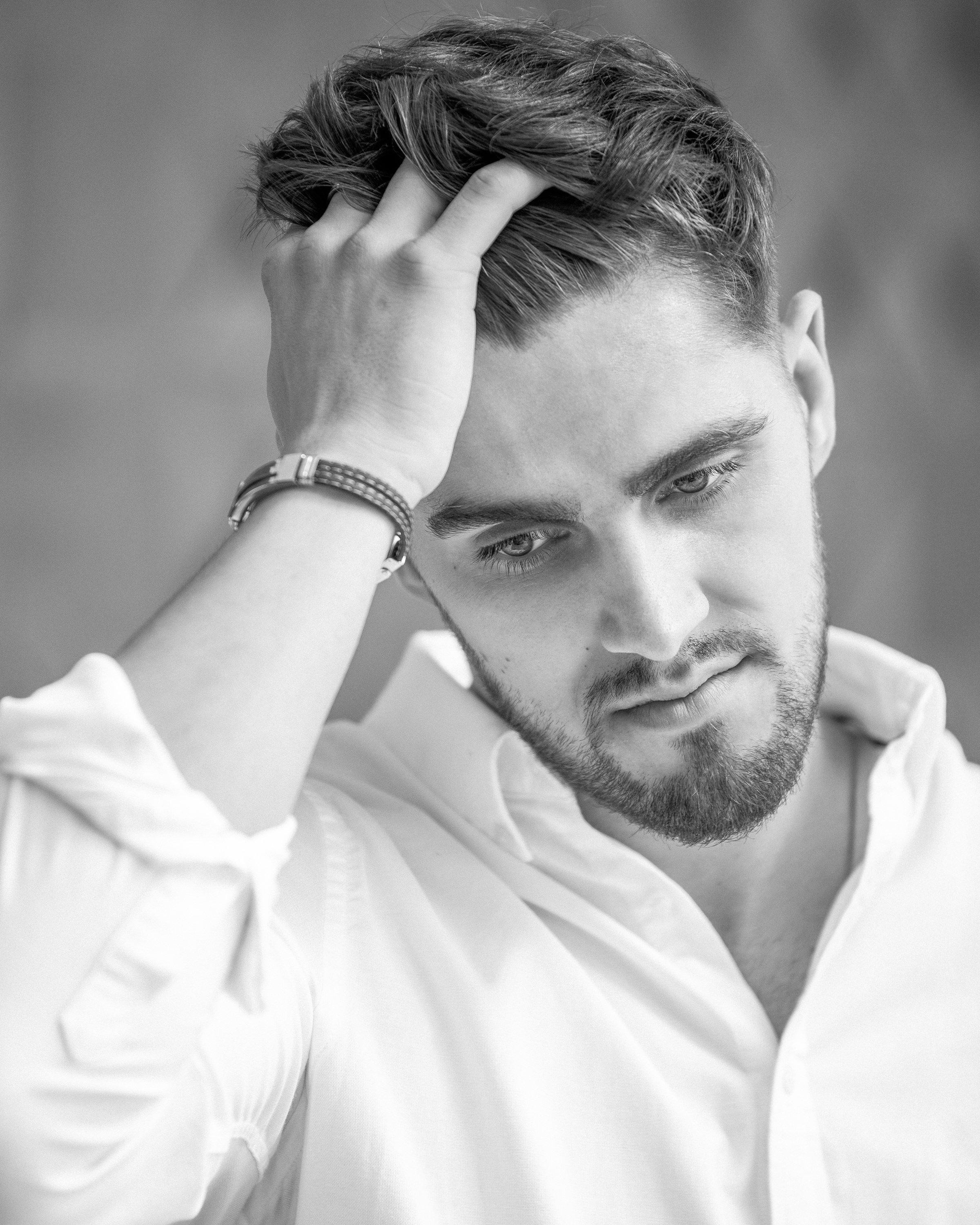 A black and white photo of a man with a beard.